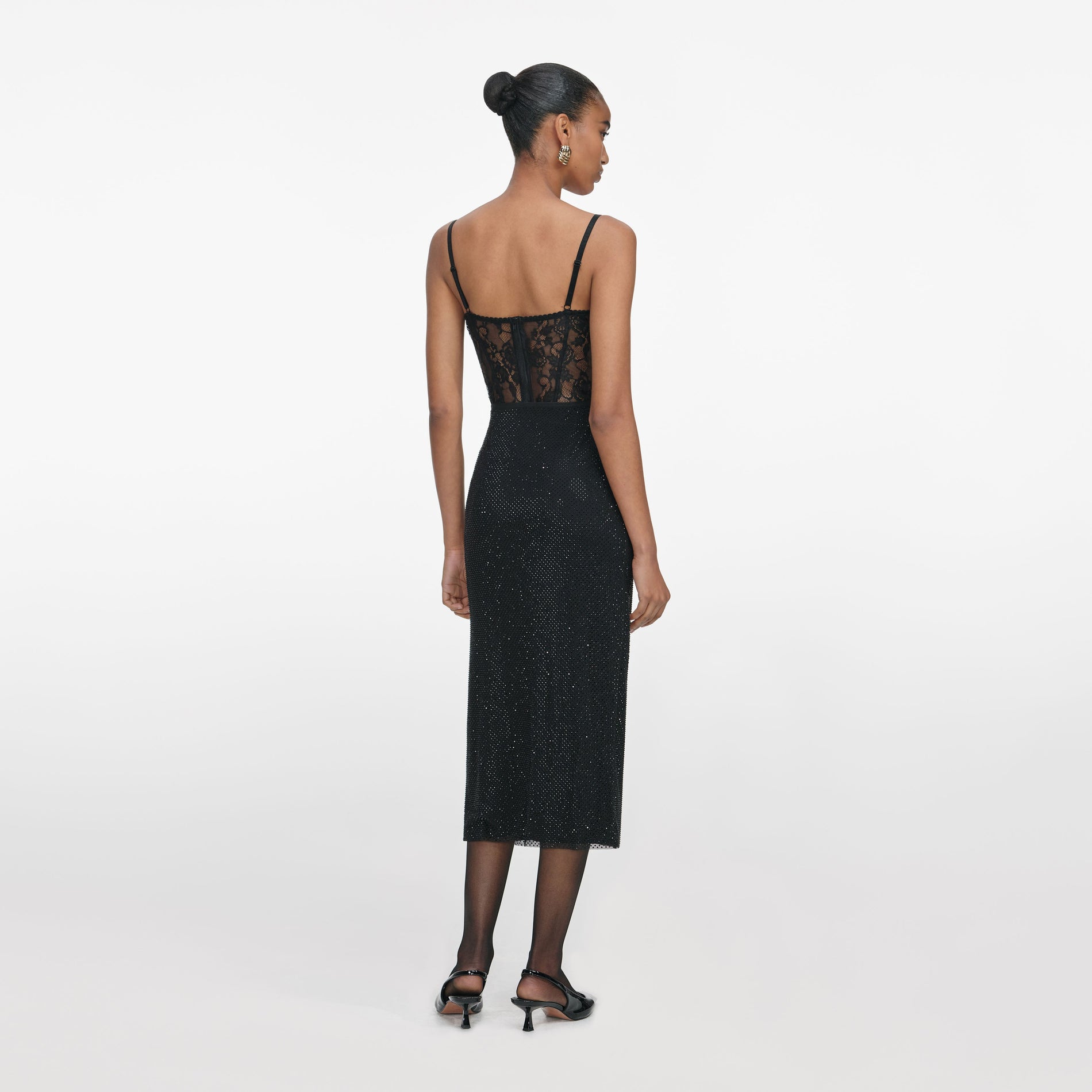Back view of a woman wearing the Black Rhinestone Midi Skirt