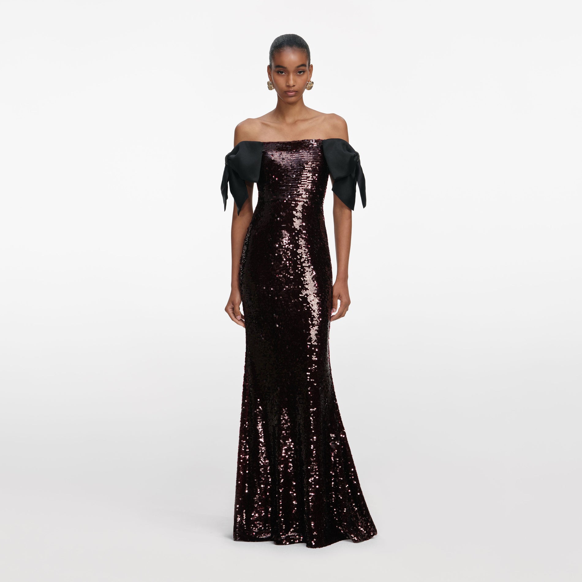 Front view of a woman wearing the Brown Sequin Bow Maxi Dress