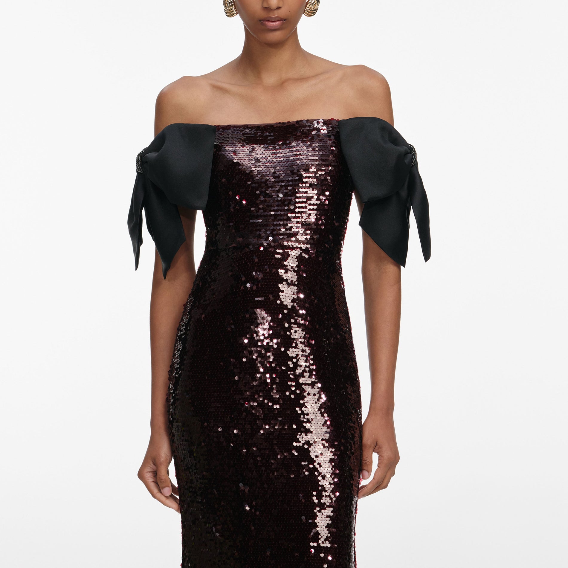 A close up of a woman wearing the Brown Sequin Bow Maxi Dress