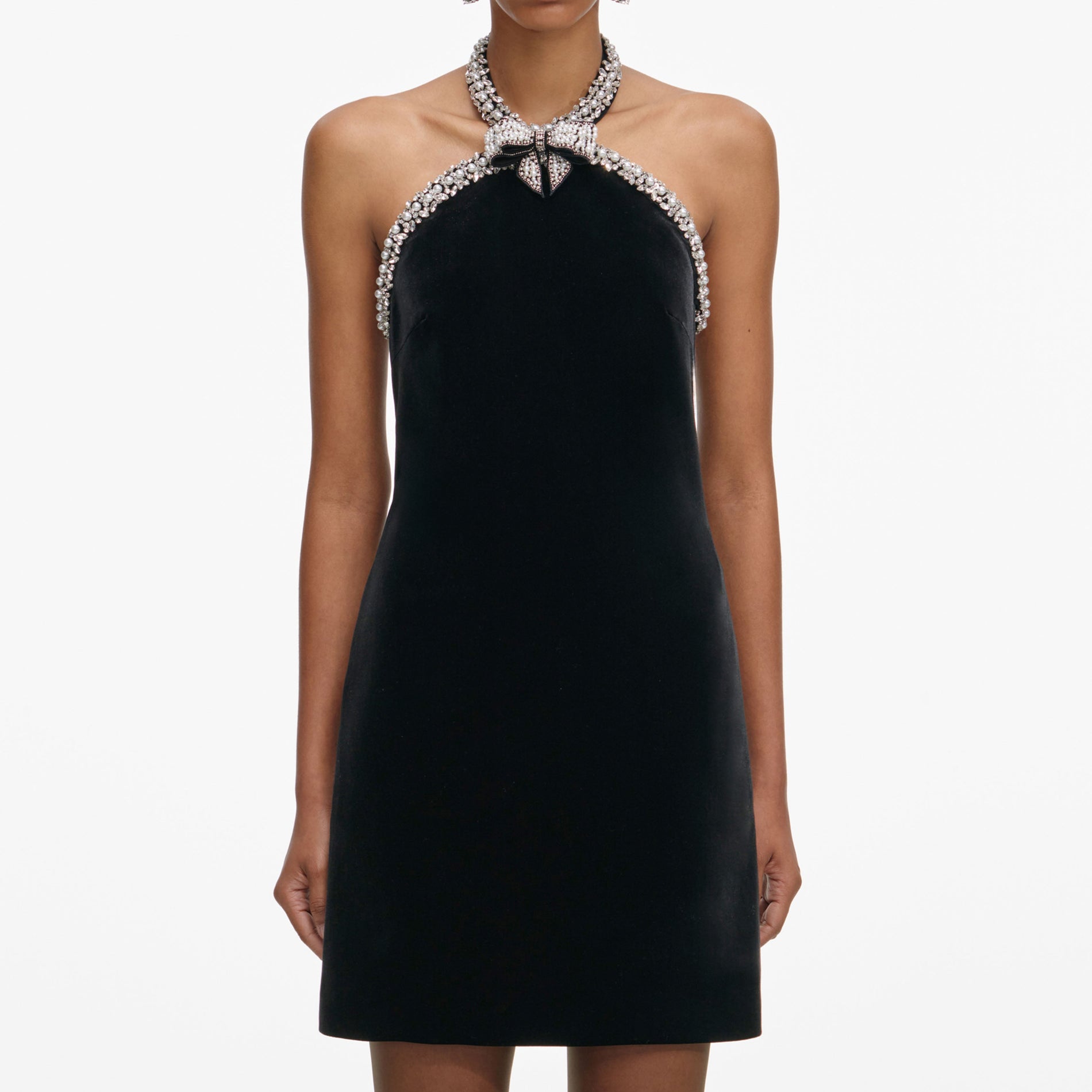 A close up of a woman wearing the Black Velvet Crystal Trim Mini Dress