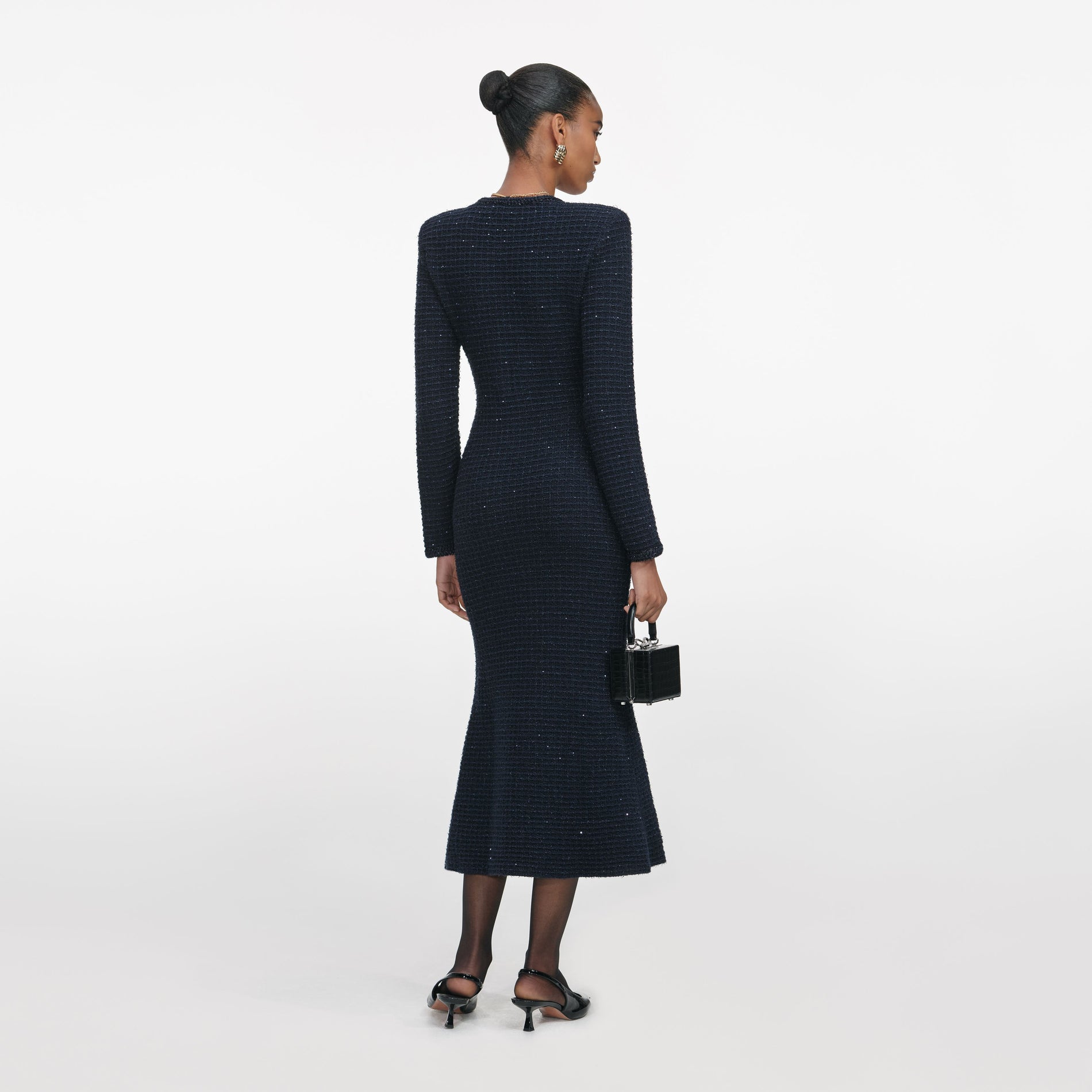 Back view of a woman wearing the Navy Textured Knit Midi Dress