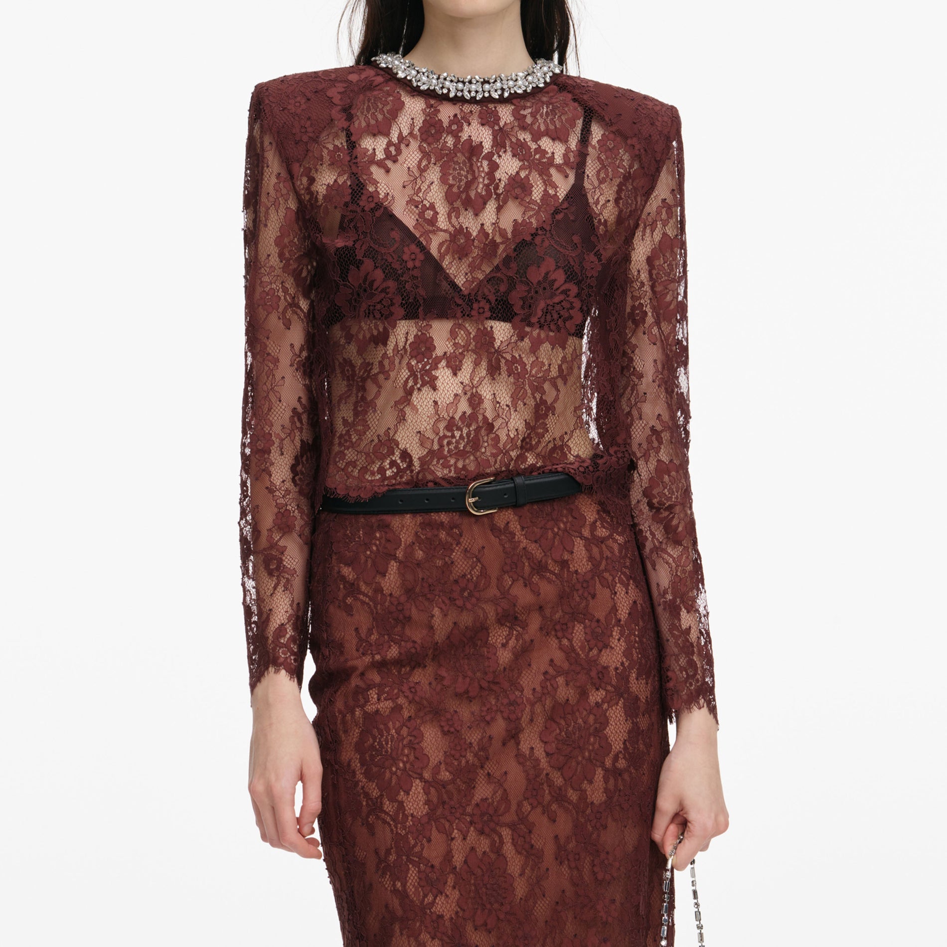 A close up of a woman wearing the Brown Floral Lace Midi Skirt