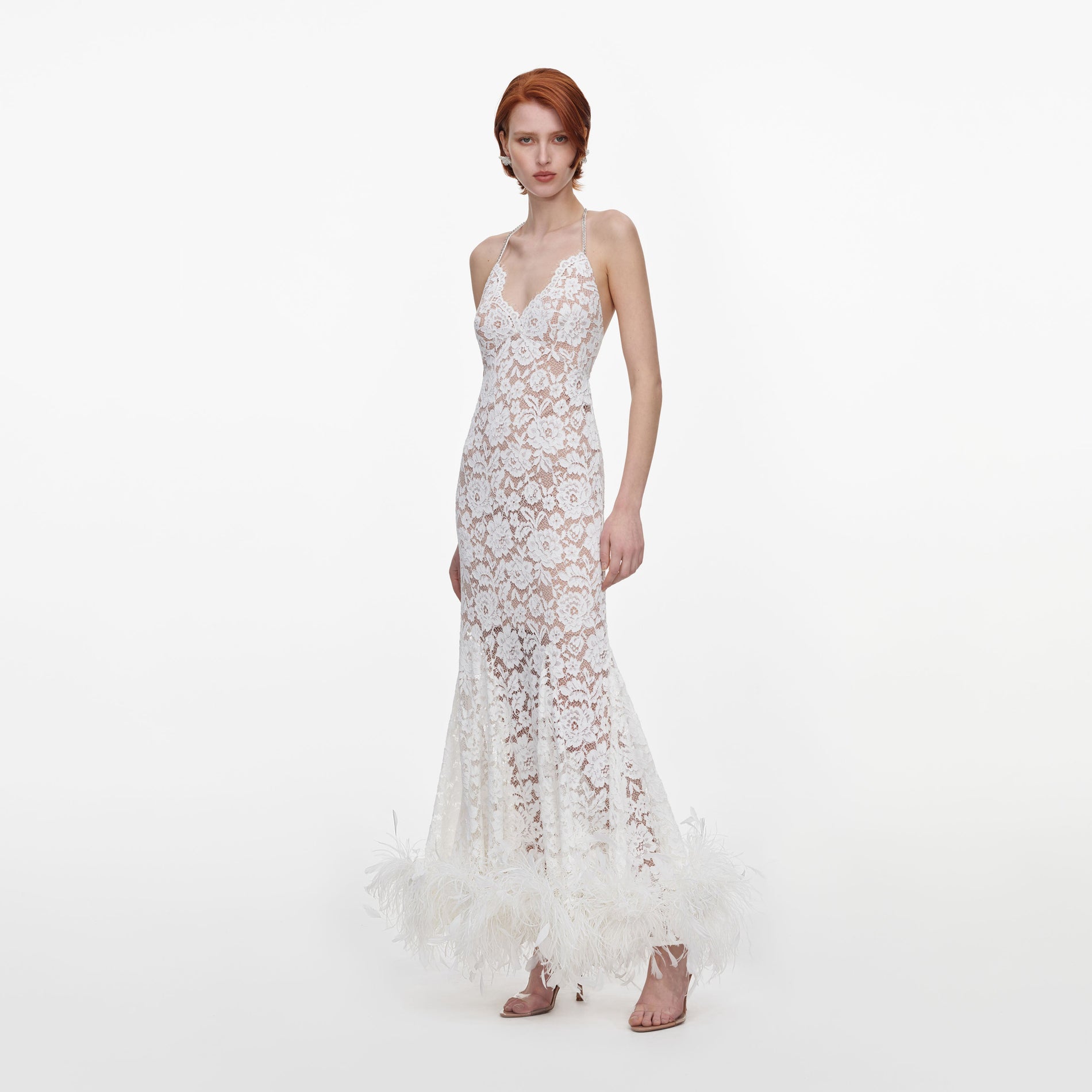 Side view of a woman wearing the White Fine Lace Feather Maxi Dress