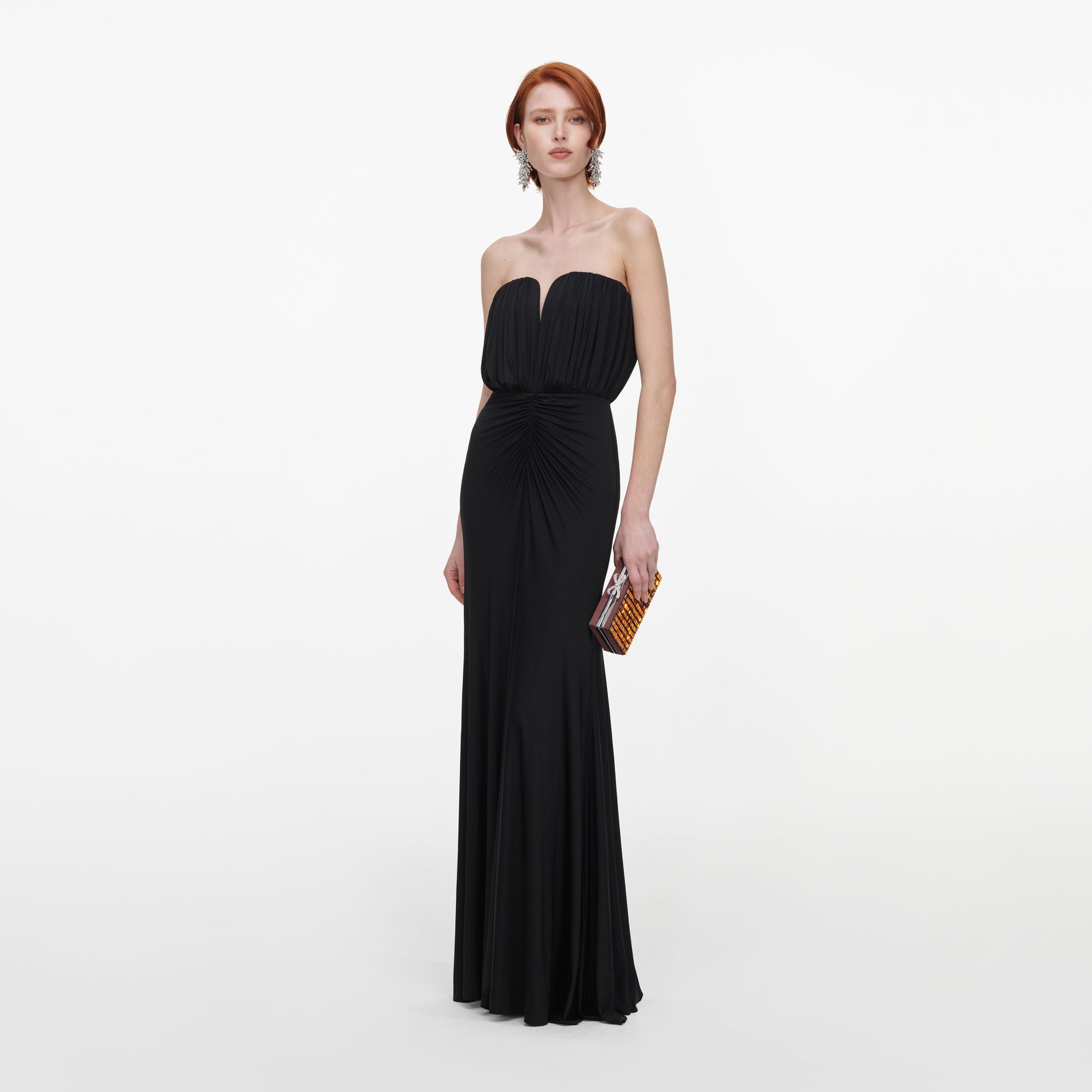 Side view of a woman wearing the Black Jersey Bandeau Maxi Dress