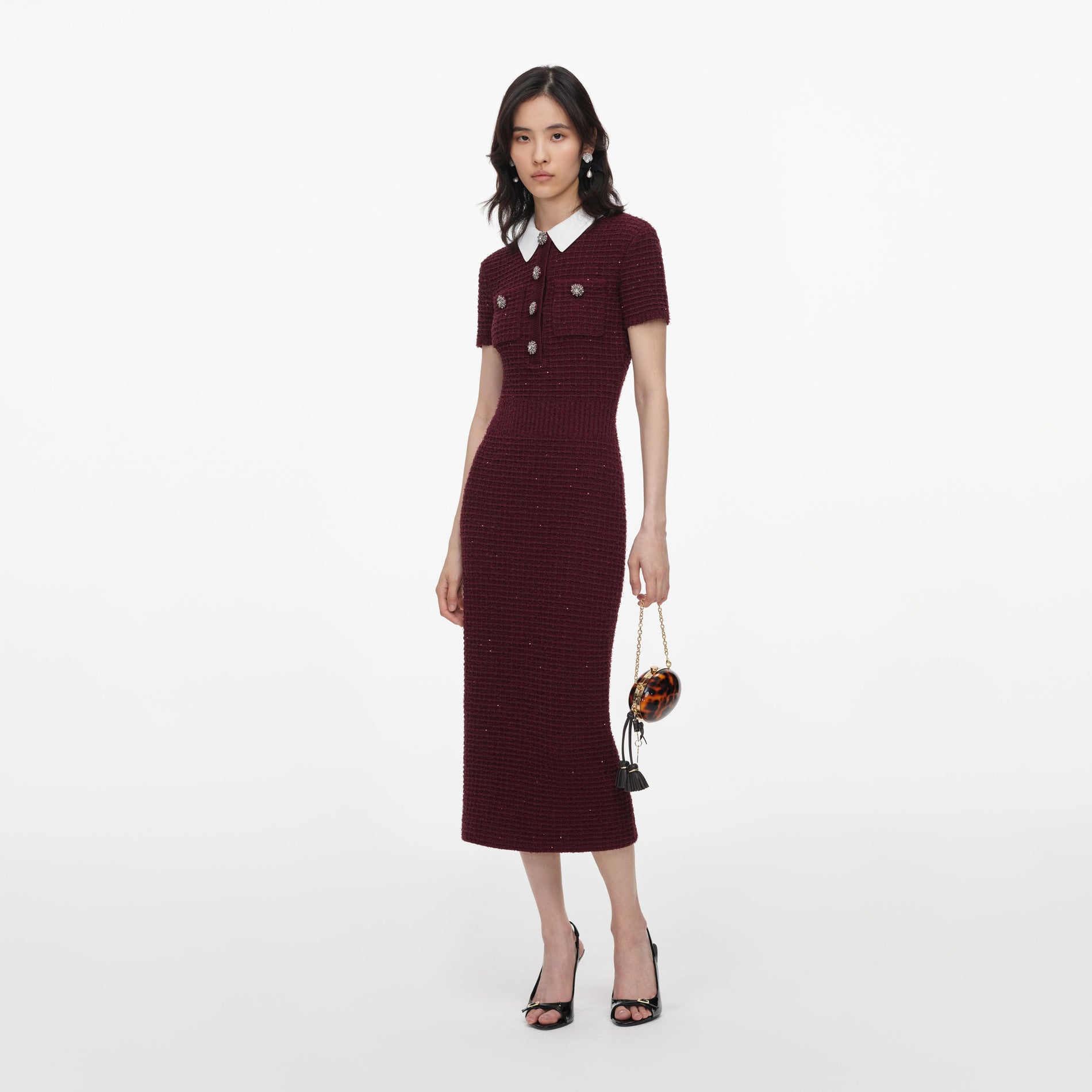 Side view of a woman wearing the Burgundy Textured Knit Midi Dress