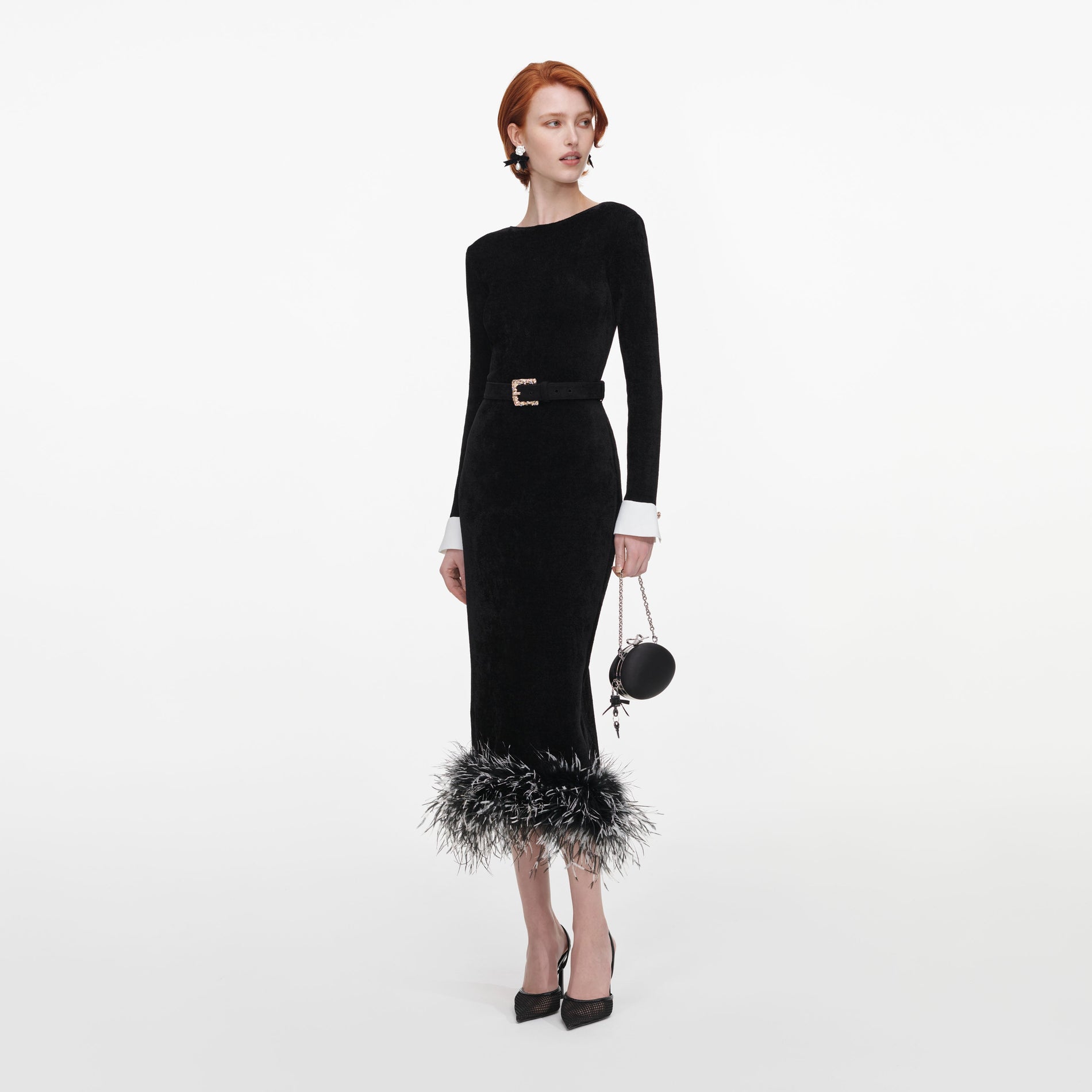 Side view of a woman wearing the Black Chenille Knit Feather Midi Dress