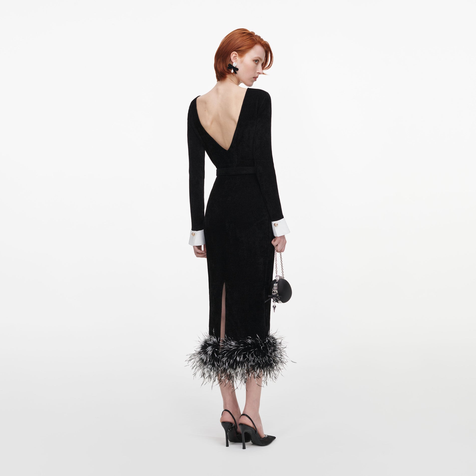 Back view of a woman wearing the Black Chenille Knit Feather Midi Dress