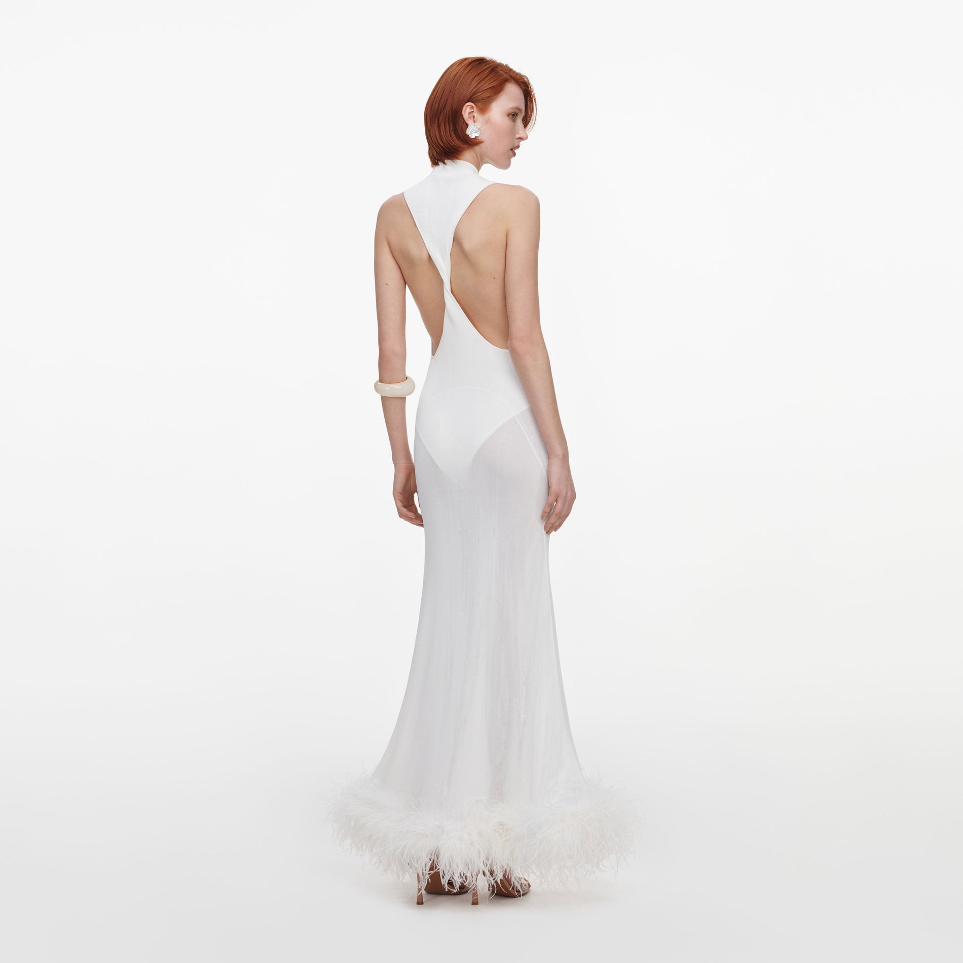 Back view of a woman wearing the White Racer Back Feather Knit Midi Dress