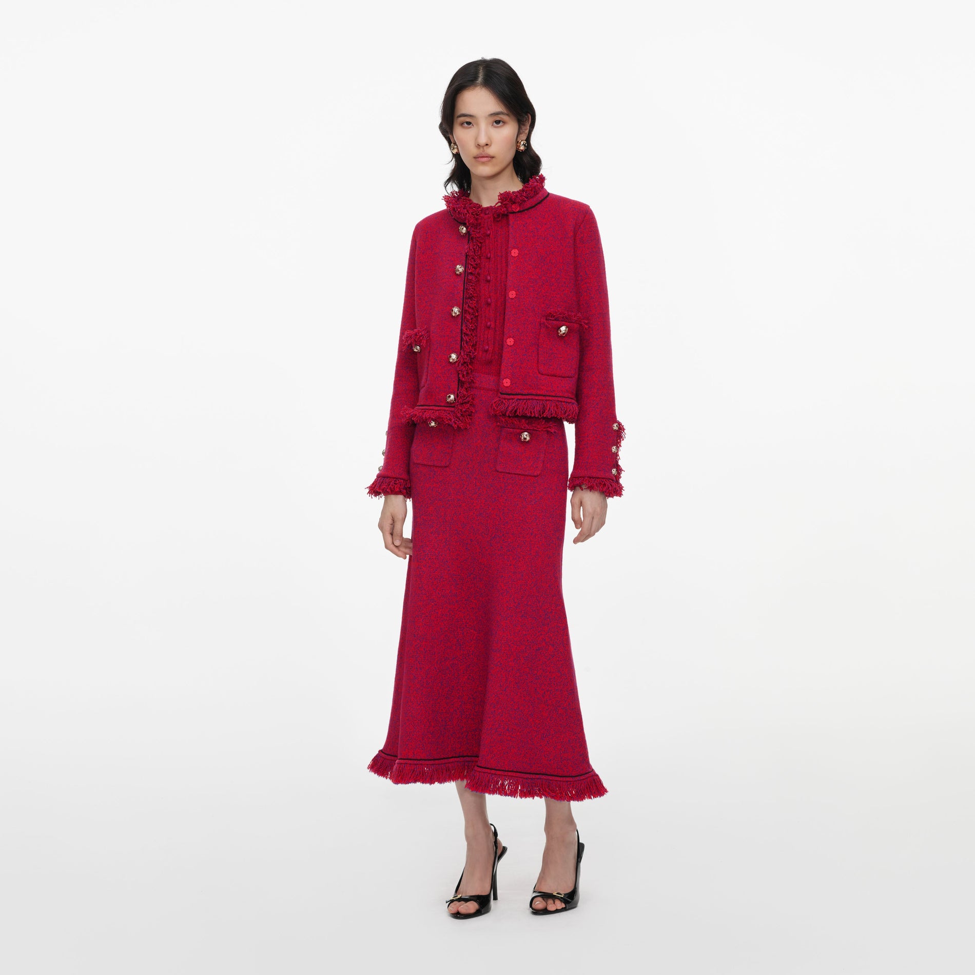 Side view of a woman wearing the Red Frayed Knit Midi Skirt