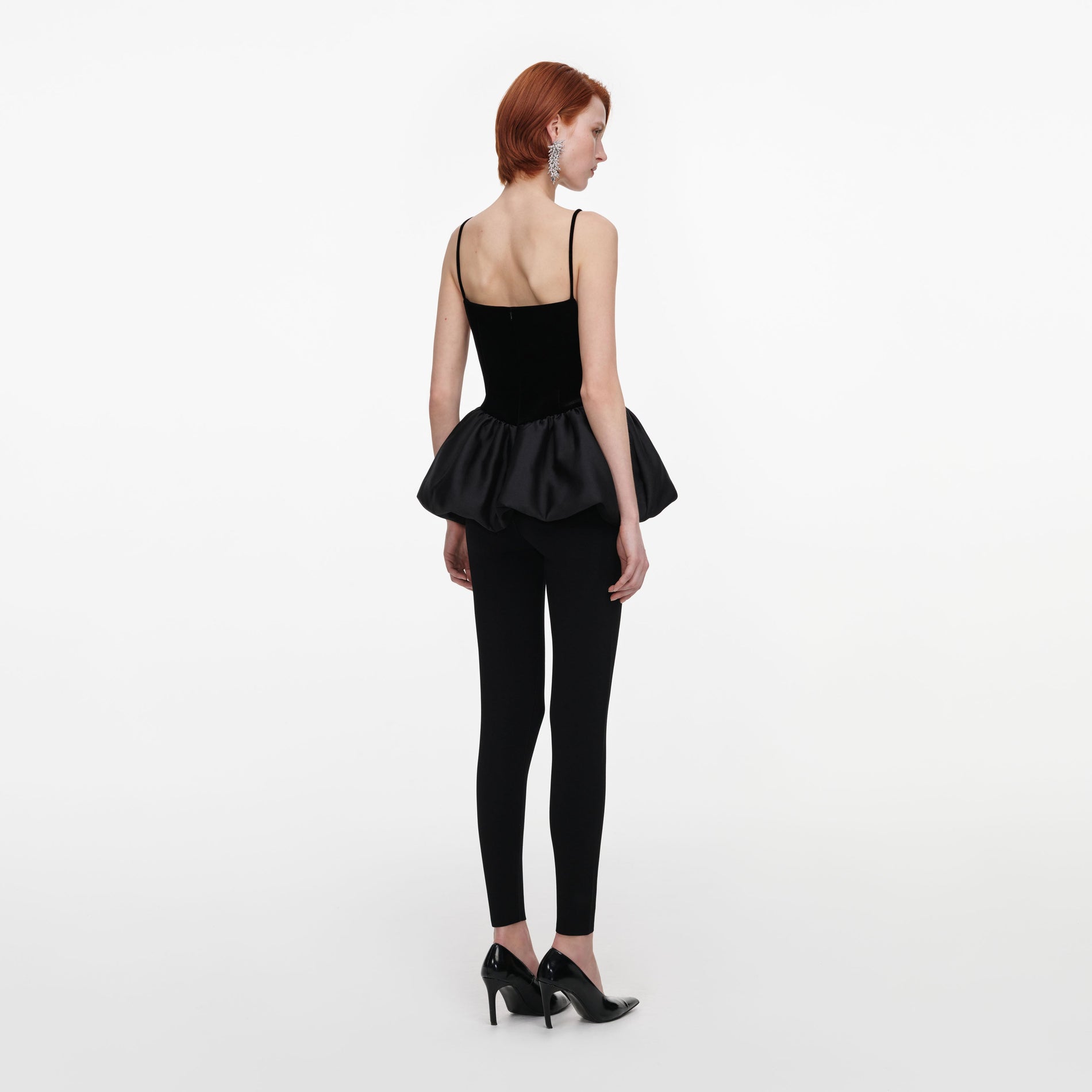Back view of a woman wearing the Black Panel Knit Leggings