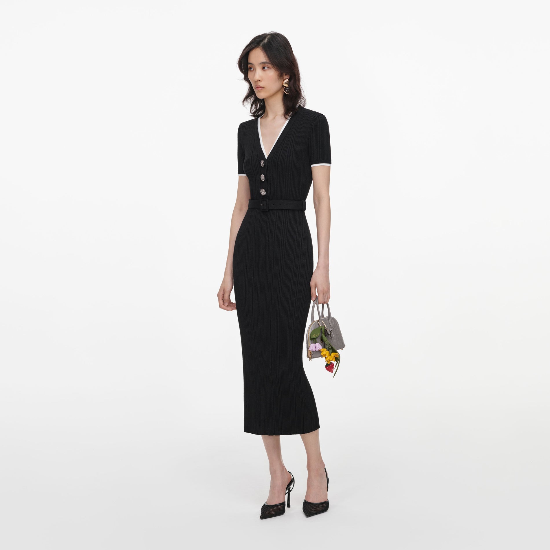 Side view of a woman wearing the Black Rib Knit Midi Dress