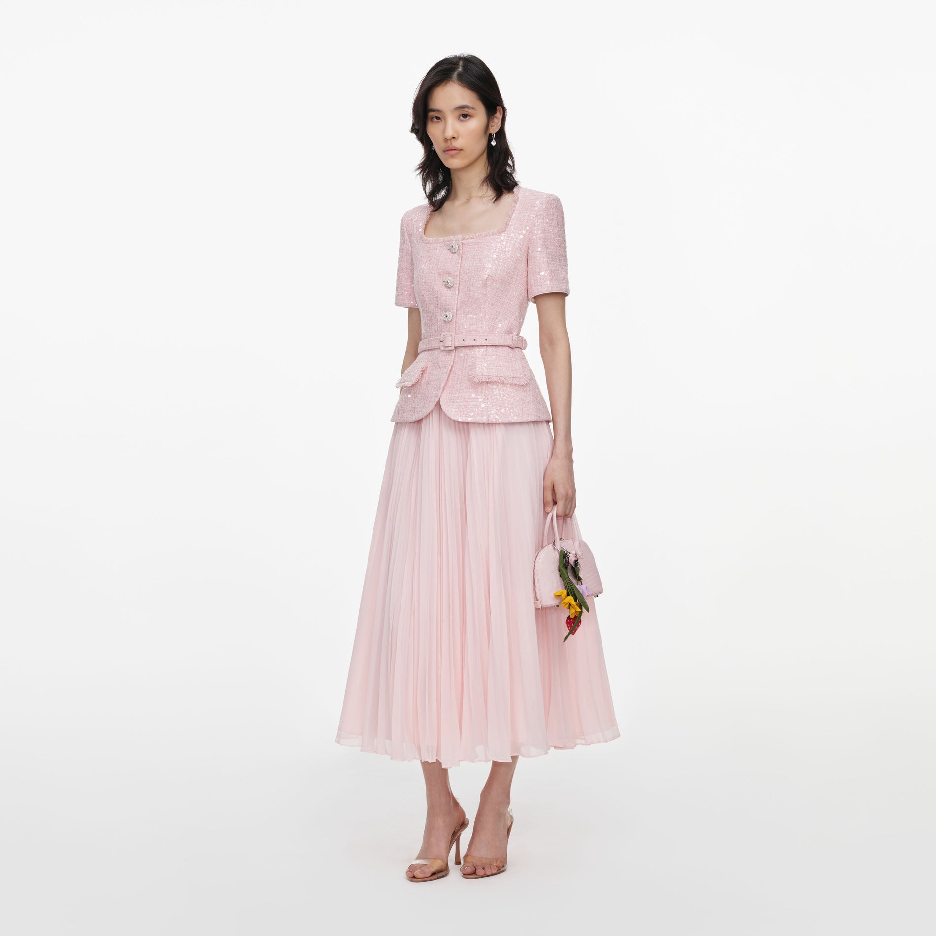 Side view of a woman wearing the Pink Sequin Boucle Midi Dress