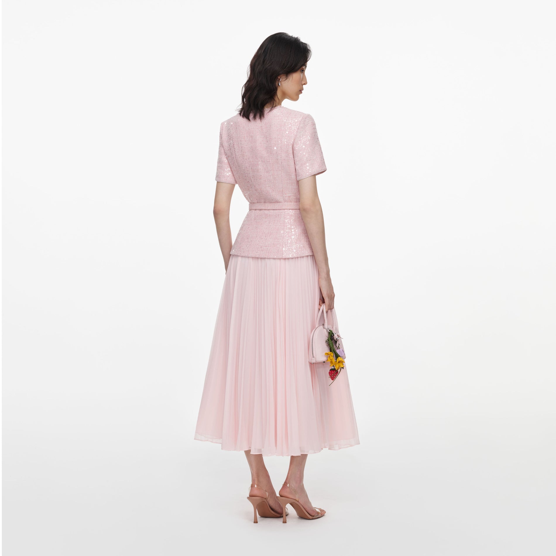 Back view of a woman wearing the Pink Sequin Boucle Midi Dress