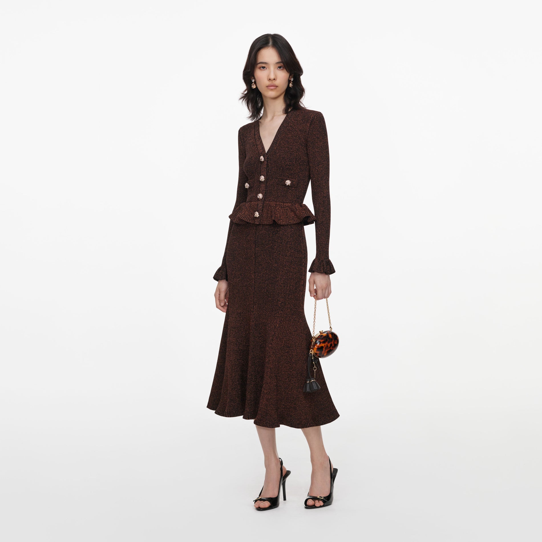 Side view of a woman wearing the Brown Lurex Peplum Knit Midi Dress
