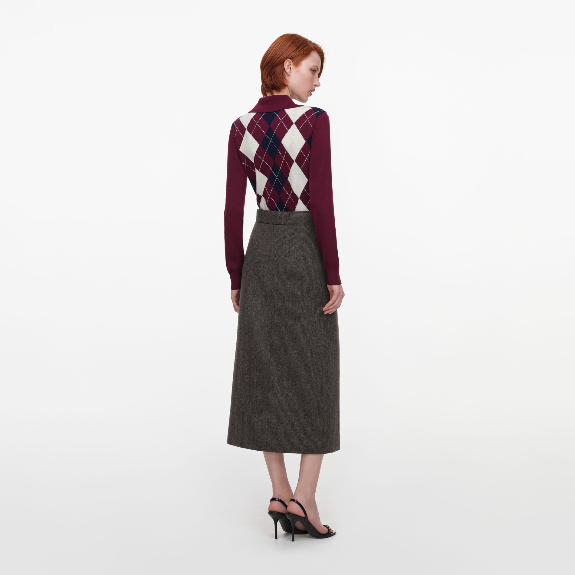 Back view of a woman wearing the Burgundy Argyle Lightweight Jumper