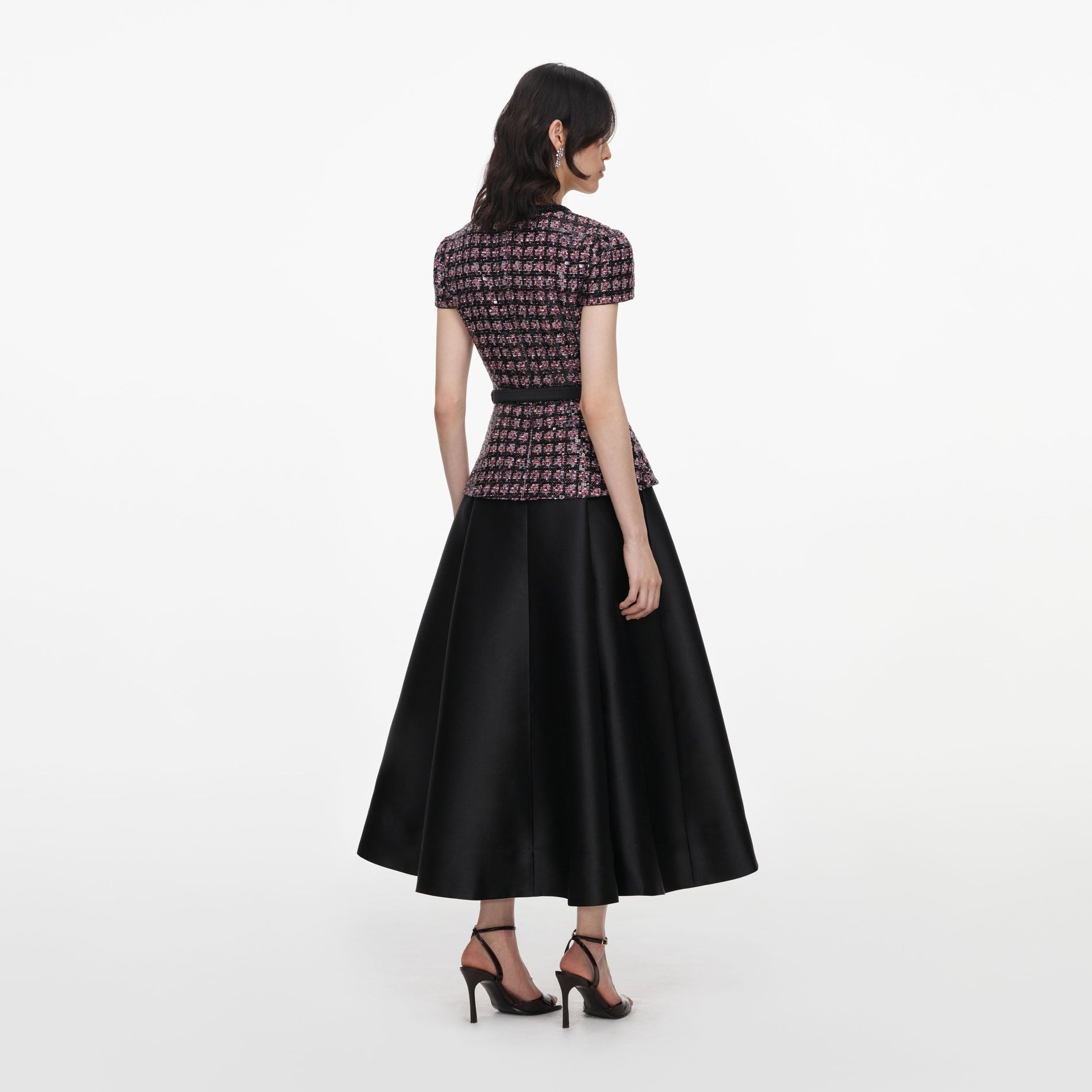 Back view of a woman wearing the Pink and Black Sequin Boucle Midi Dress