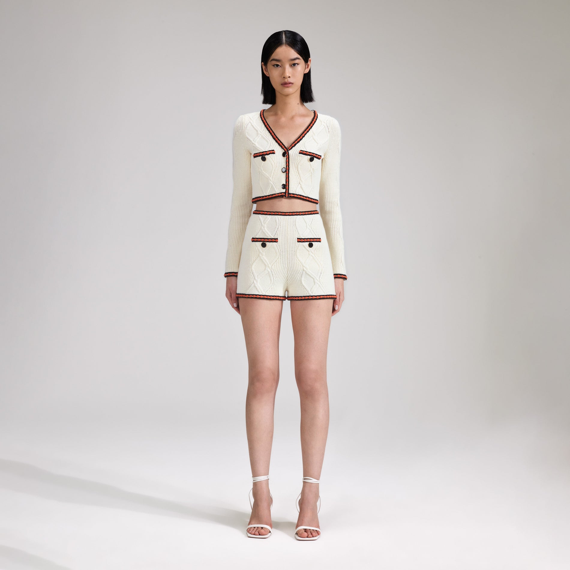 A woman wearing the Cream Cable Knit Short