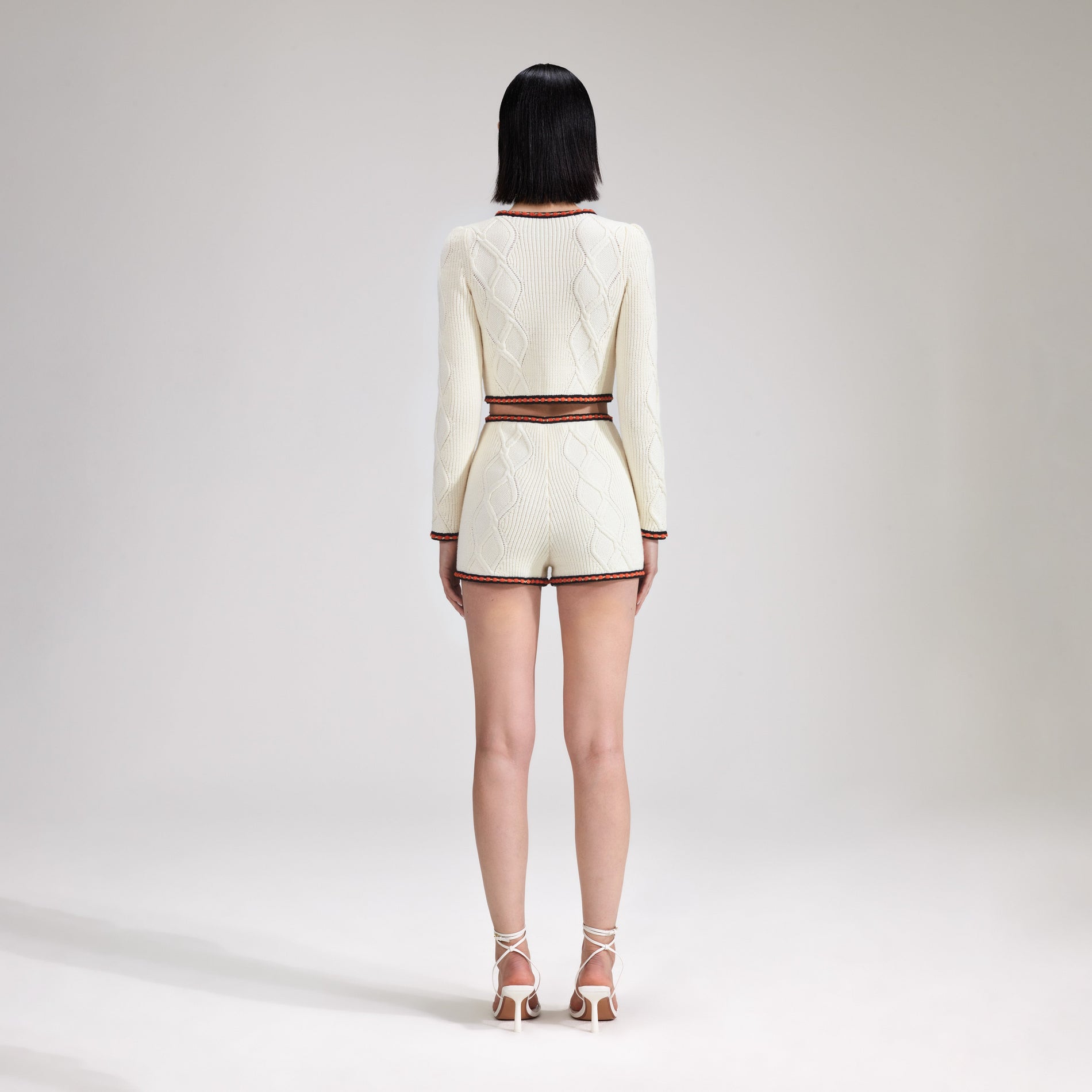 A woman wearing the Cream Cable Knit Short