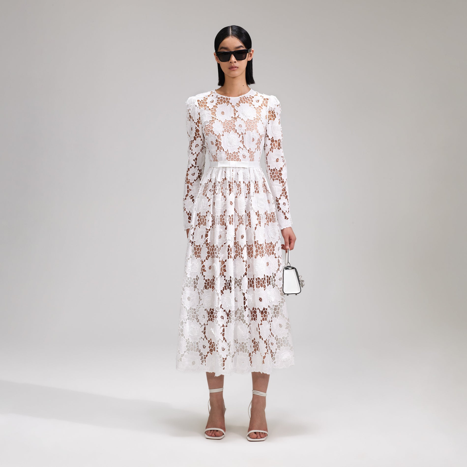 A woman wearing the White 3D Cotton Lace Midi Dress