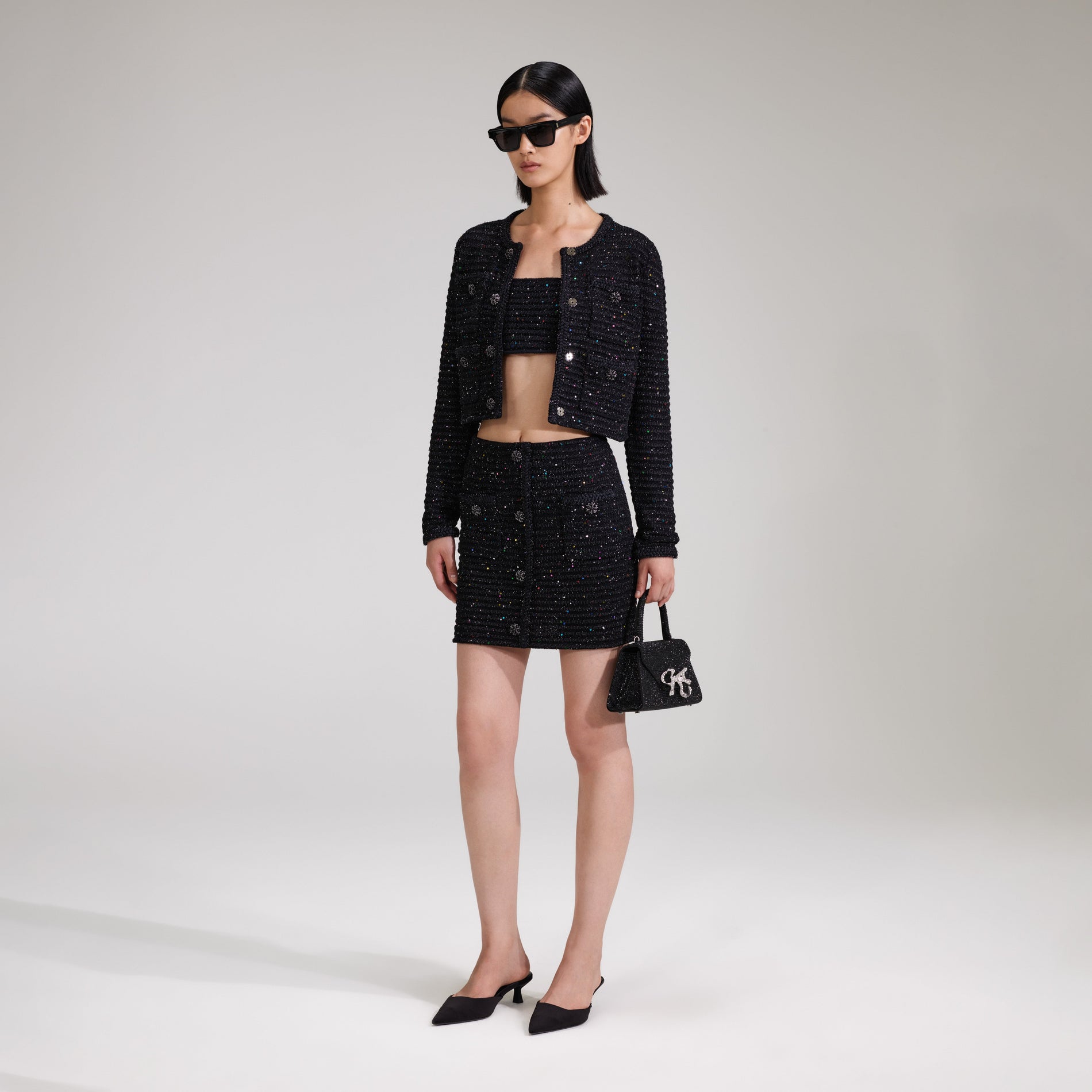 A woman wearing the Black Sequin Knit Skirt