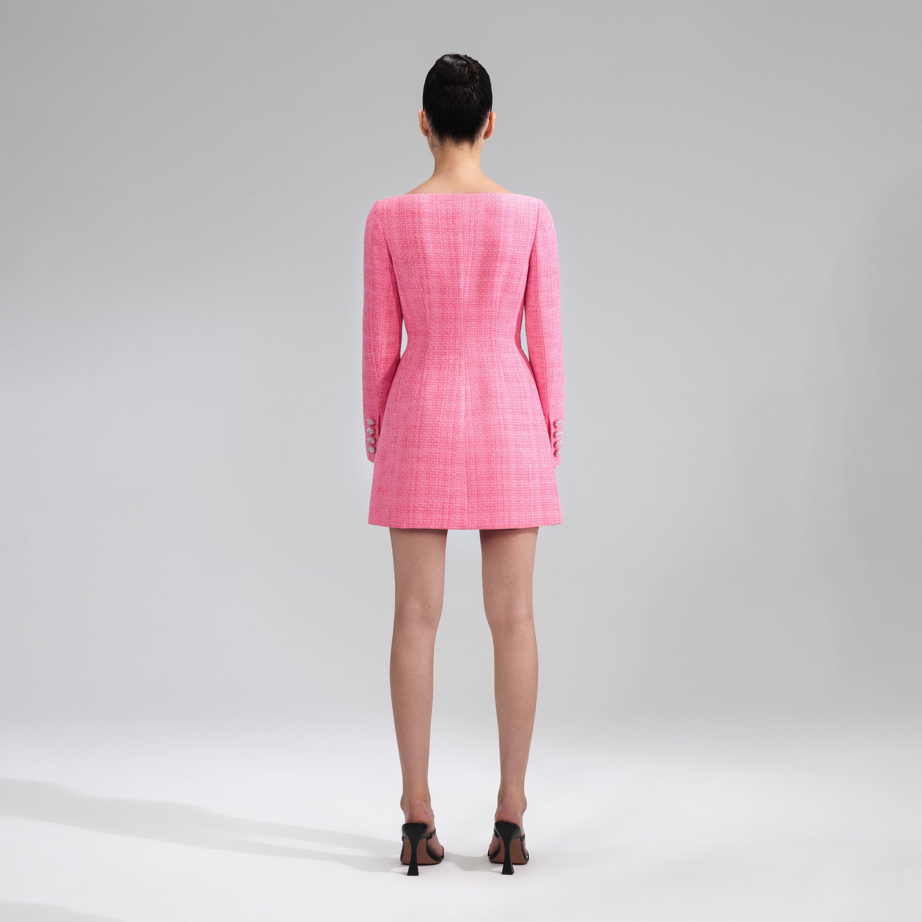 A woman wearing the Pink Boucle Mini Dress