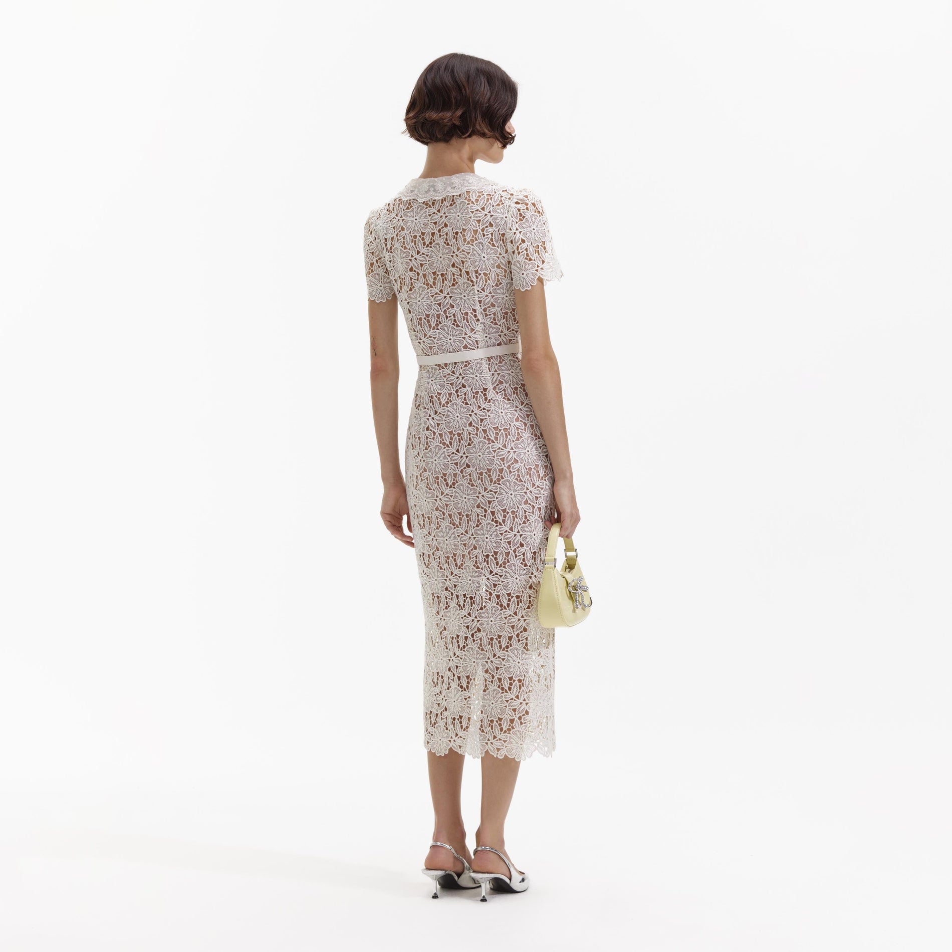 Back view of a woman wearing the Cream Lace Midi Dress