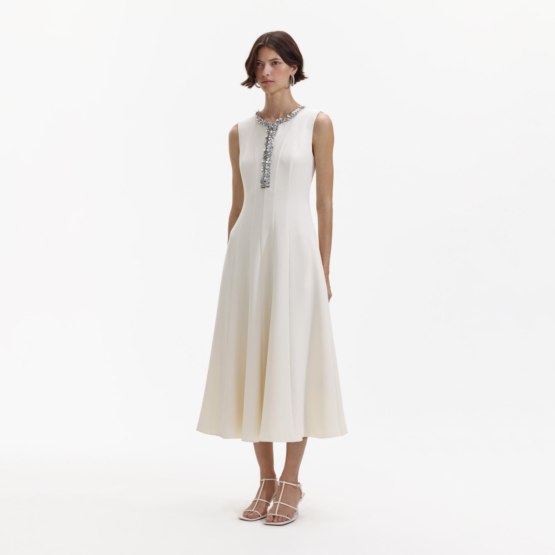 Side view of a woman wearing the Cream Crepe Embellished Midi Dress