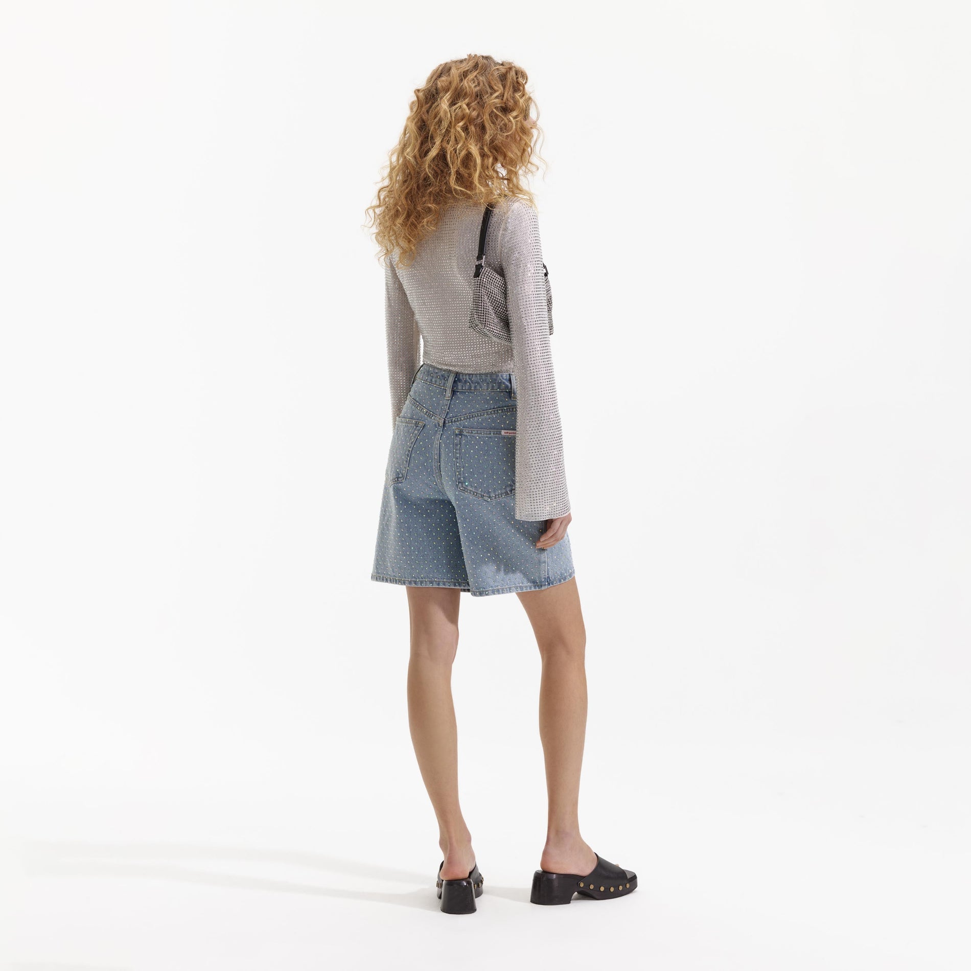 Back view of a woman wearing the Cream Rhinestone Shirt