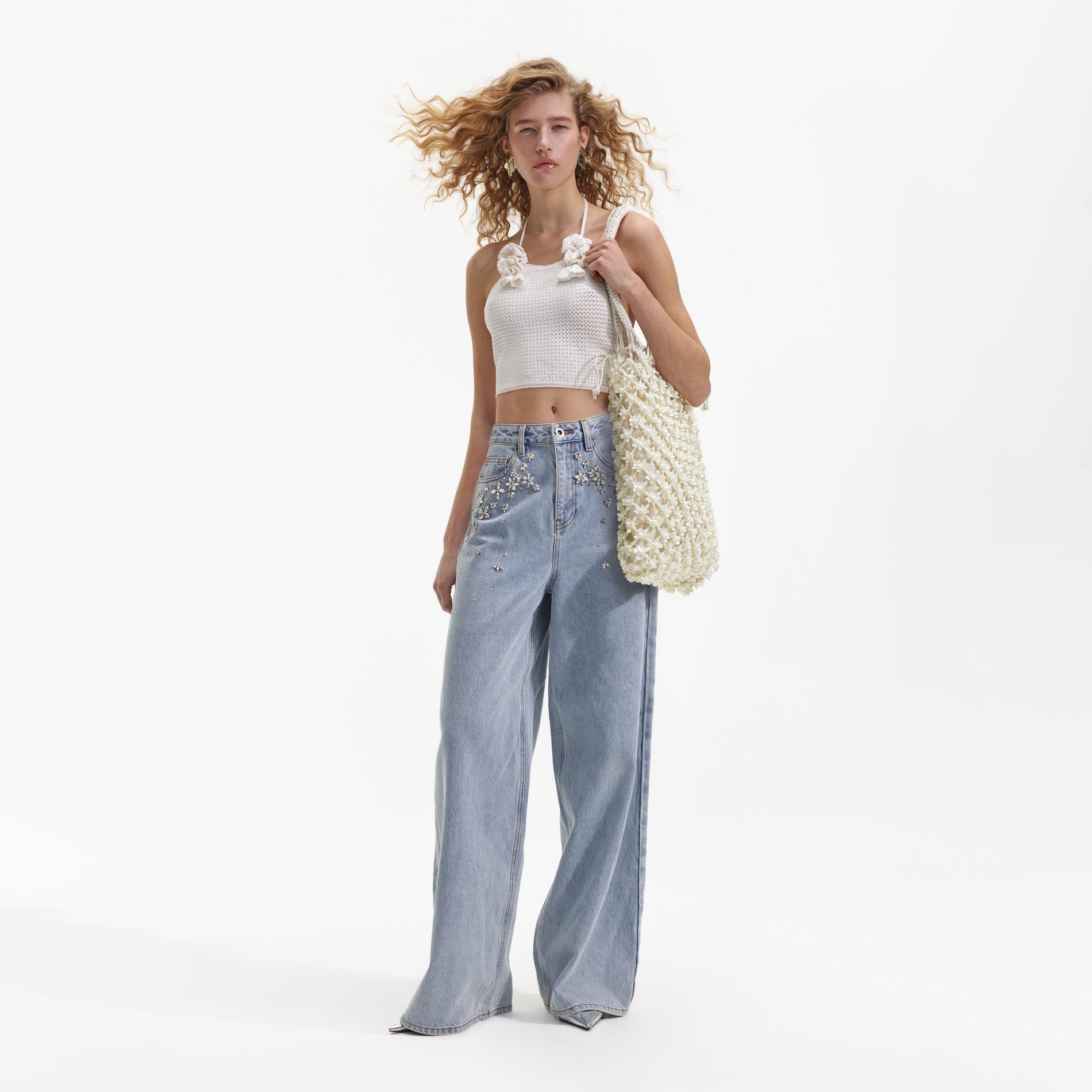 Front view of a woman wearing the White Crochet Crop Top