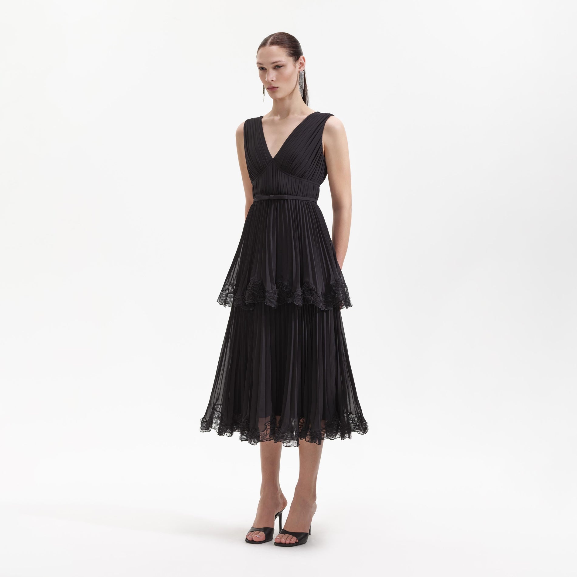 Side view of a woman wearing the Black Chiffon Tier Midi Dress