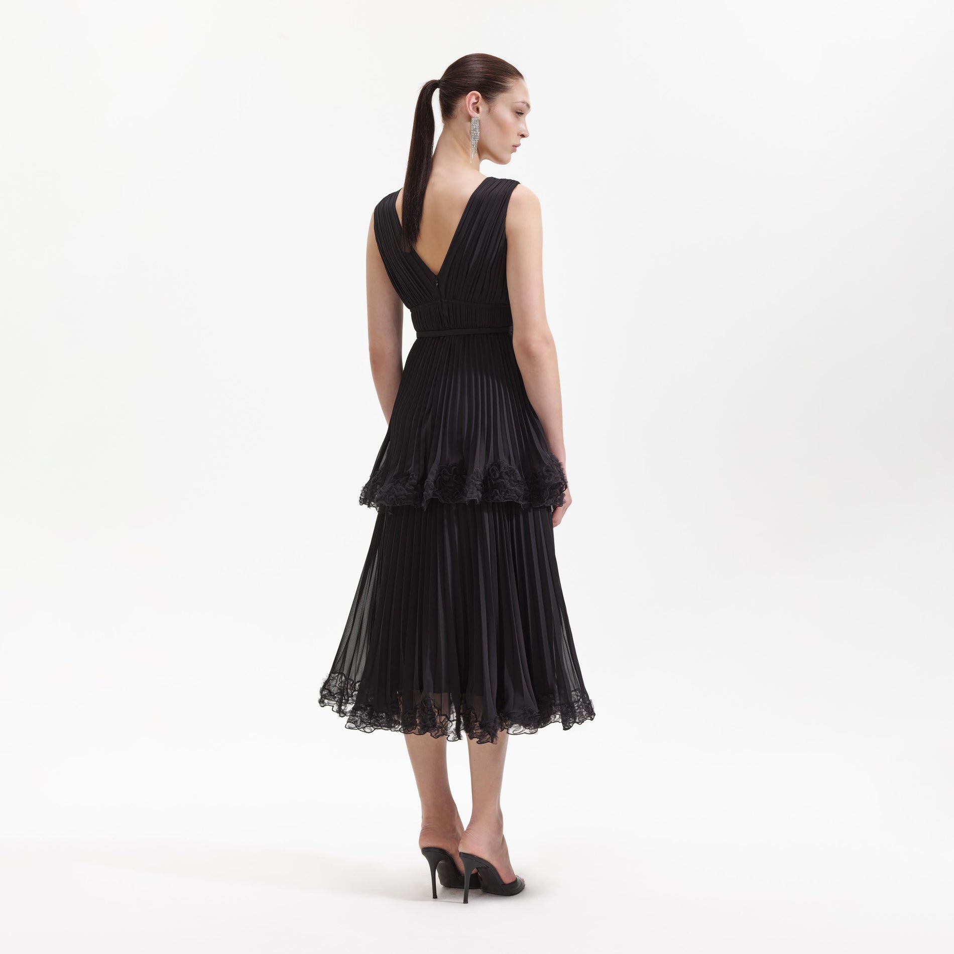 Back view of a woman wearing the Black Chiffon Tier Midi Dress
