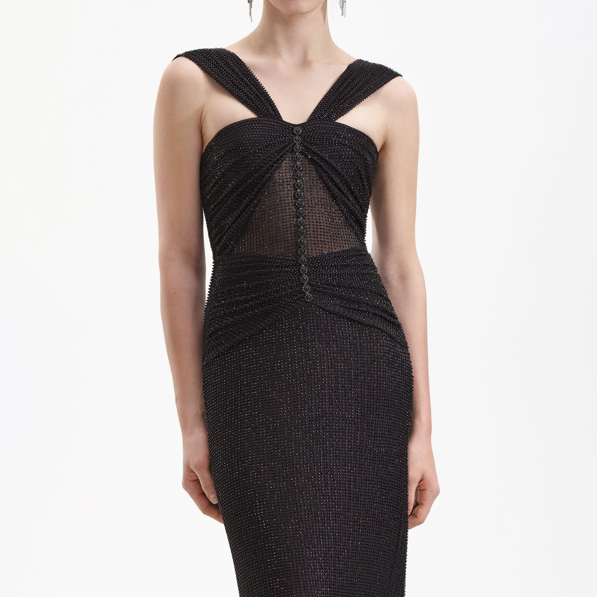 A close up of a woman wearing the Black Beaded Mesh Maxi Dress