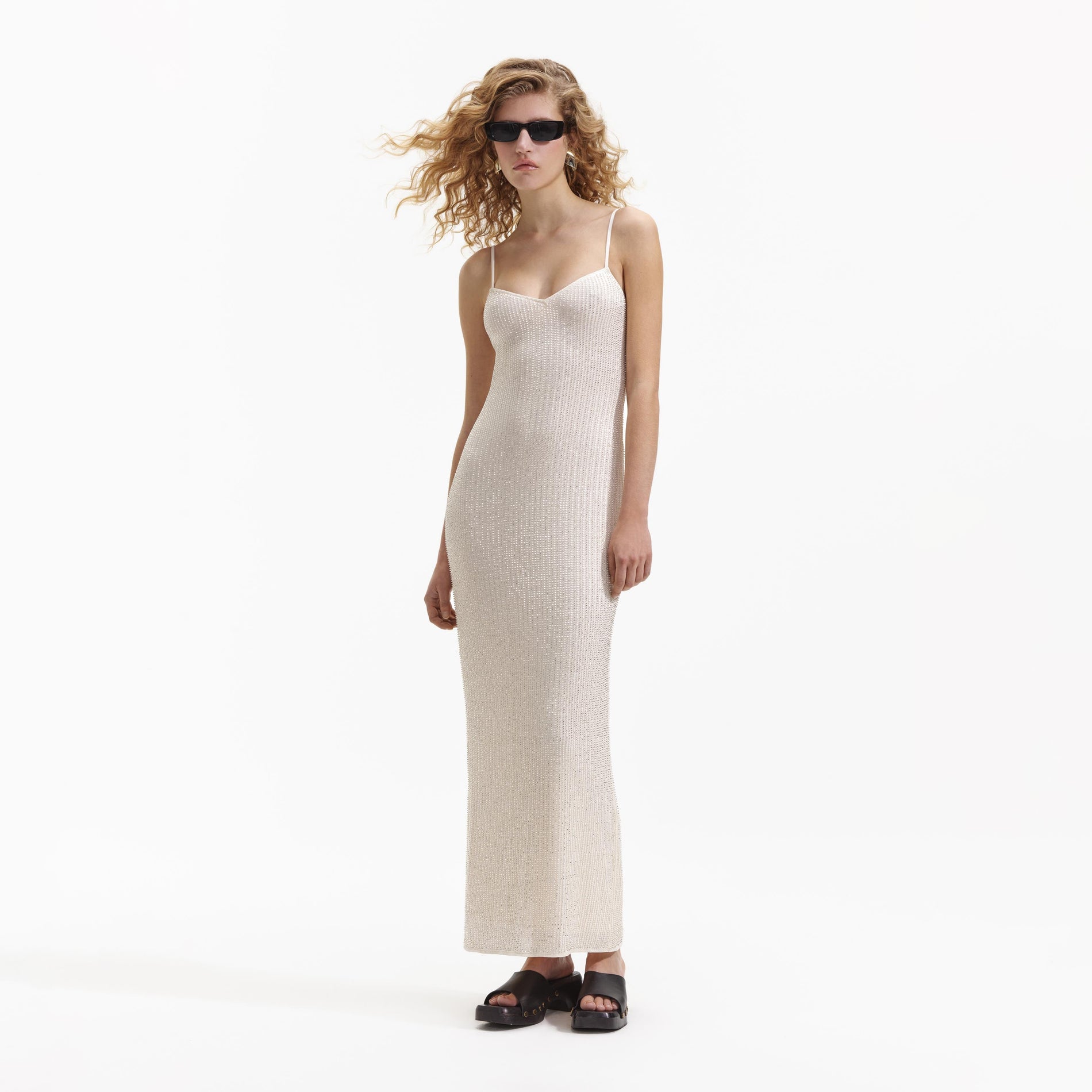 Side view of a woman wearing the Cream Beaded Mesh Maxi Dress