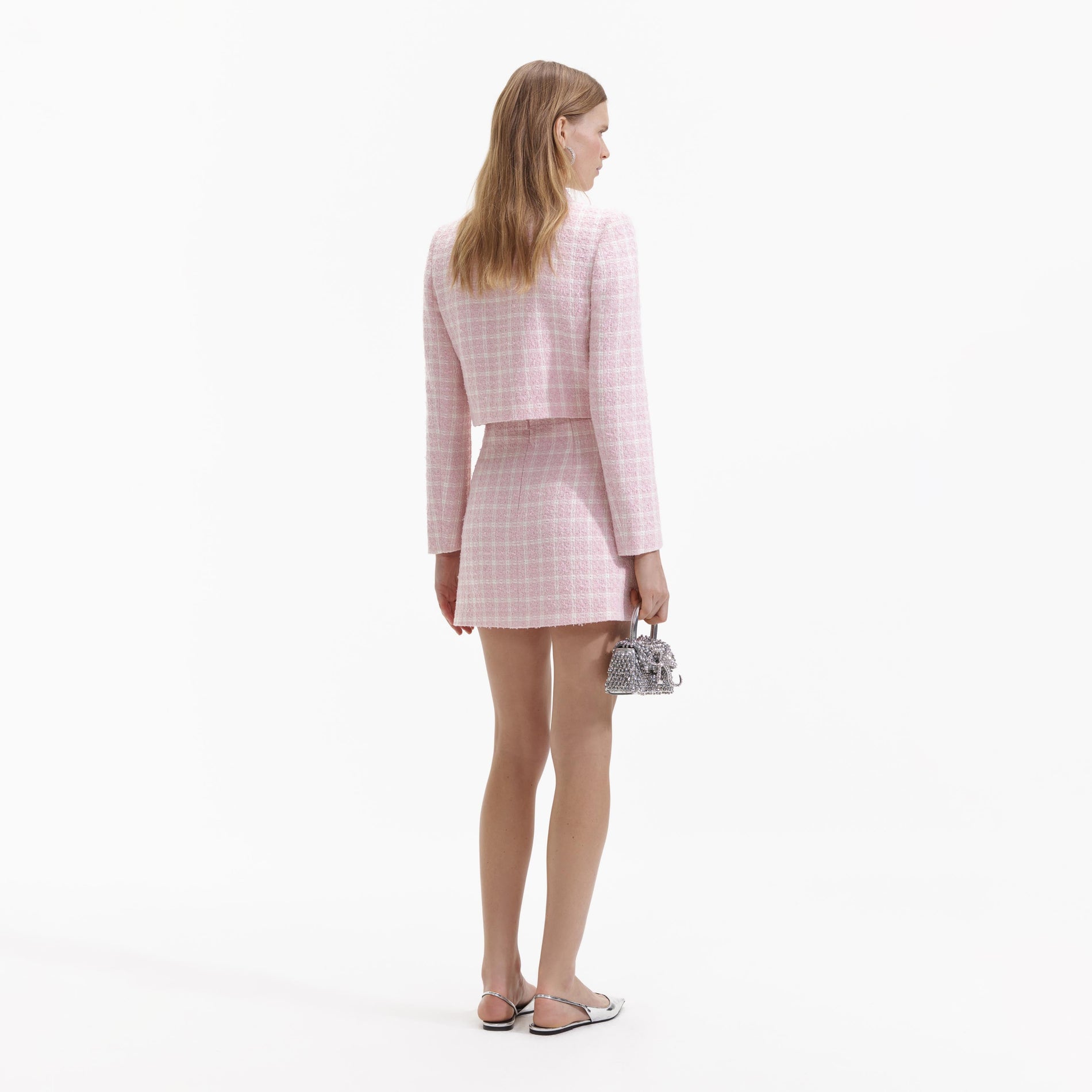 A Woman wearing the Pink Boucle Button Mini Skirt