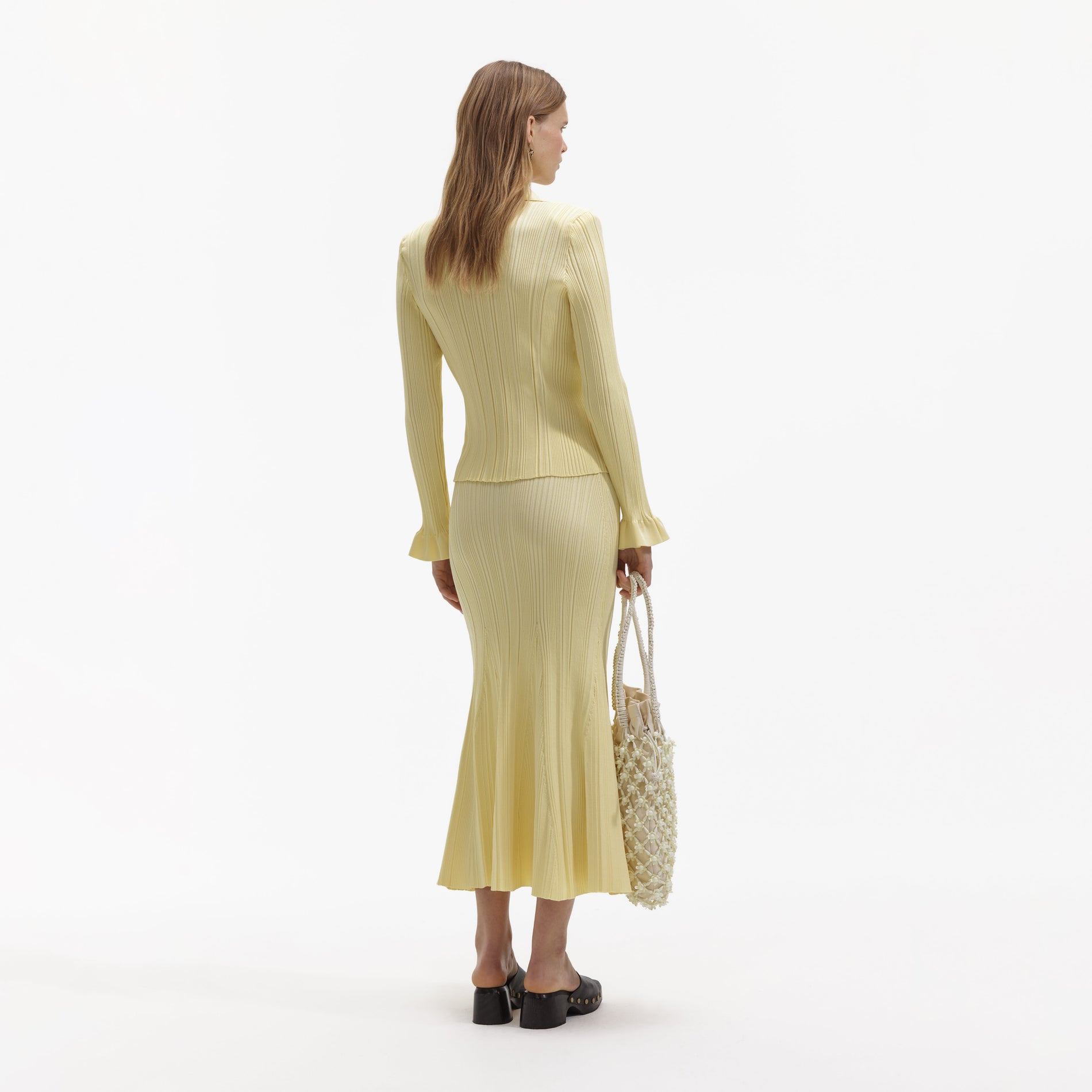 A Woman wearing the Yellow Ribbed Viscose Knit Skirt