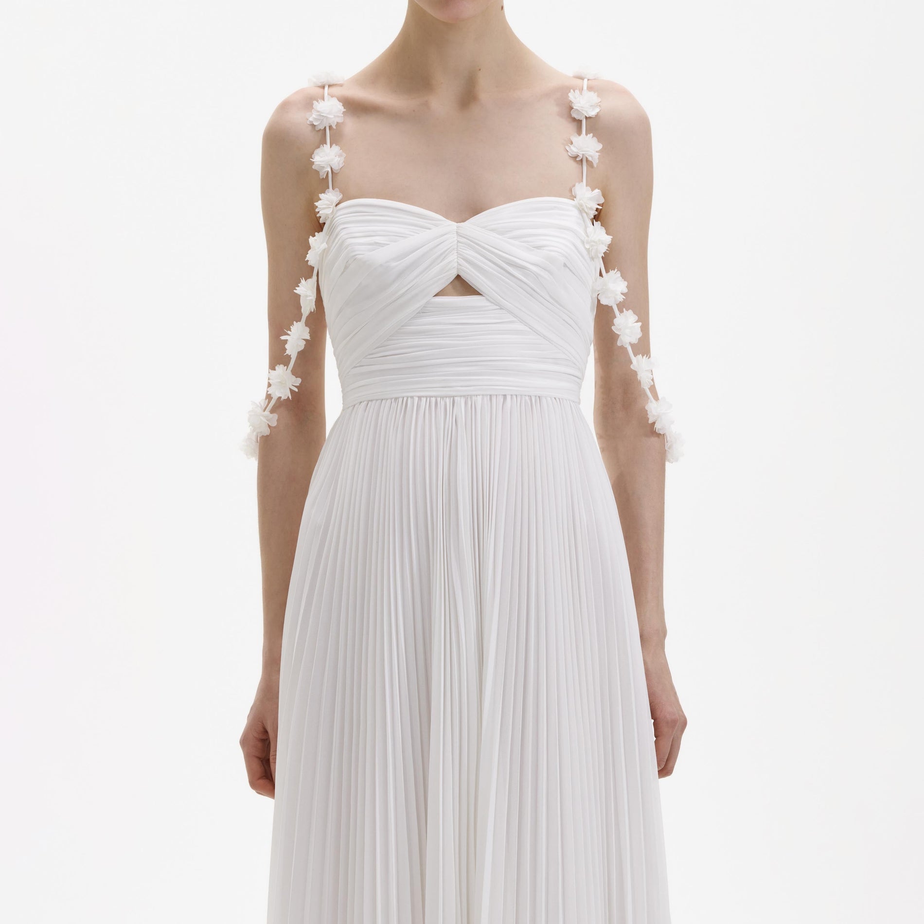 A close up of a woman wearing the White Chiffon Flower Maxi Dress