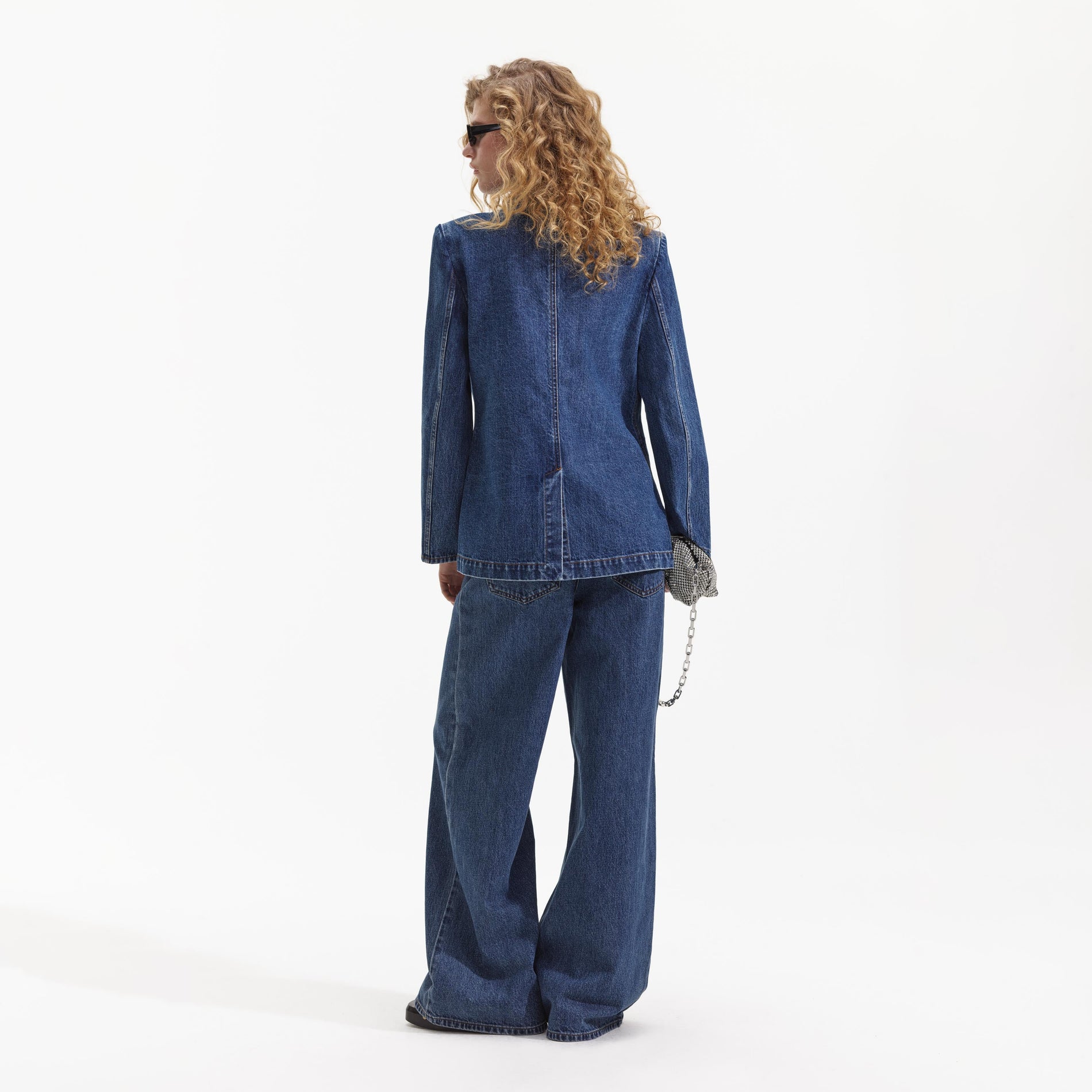 A close up of a woman wearing the Oversized Denim Blazer