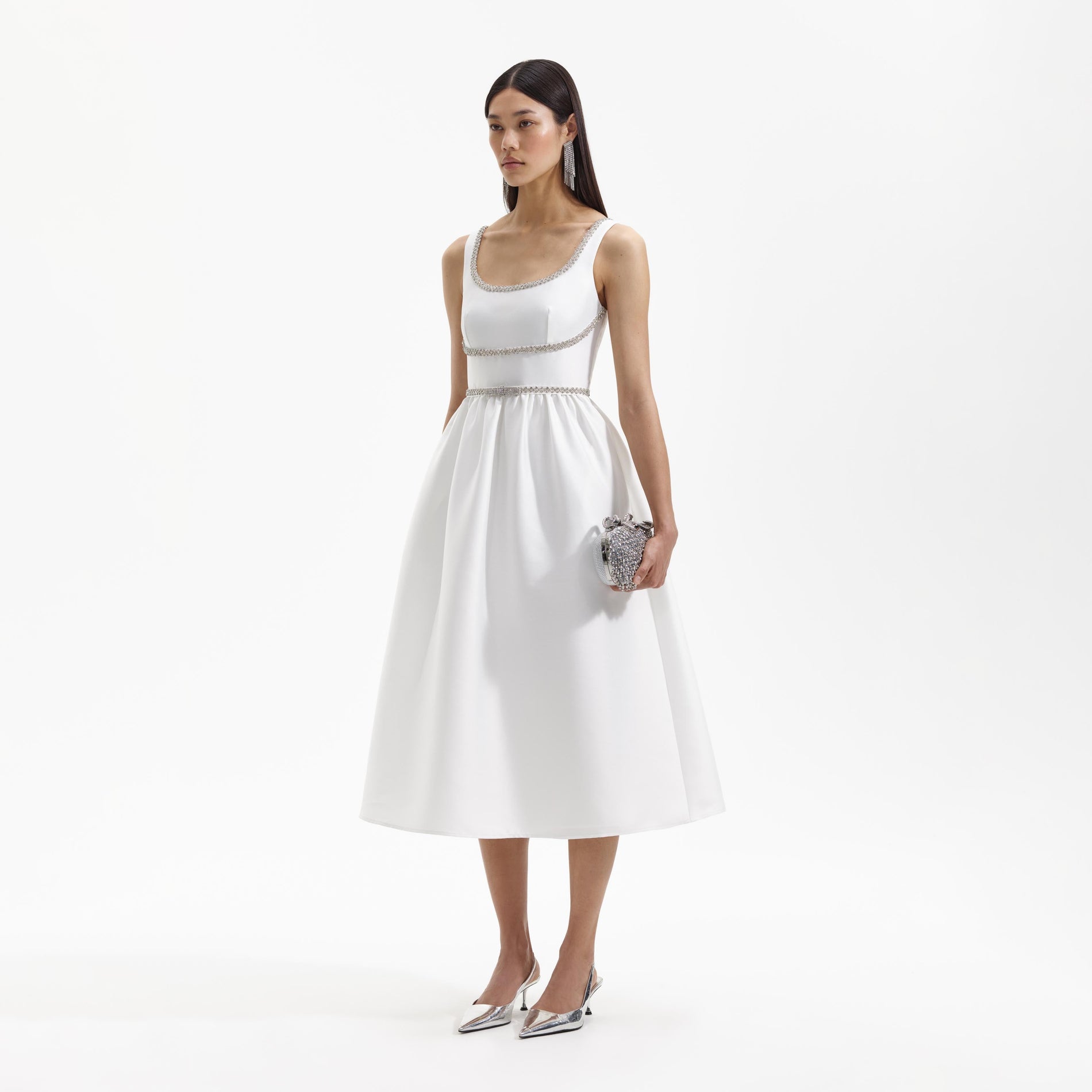 Side view of a woman wearing the White Taffeta Diamante Bow Midi Dress