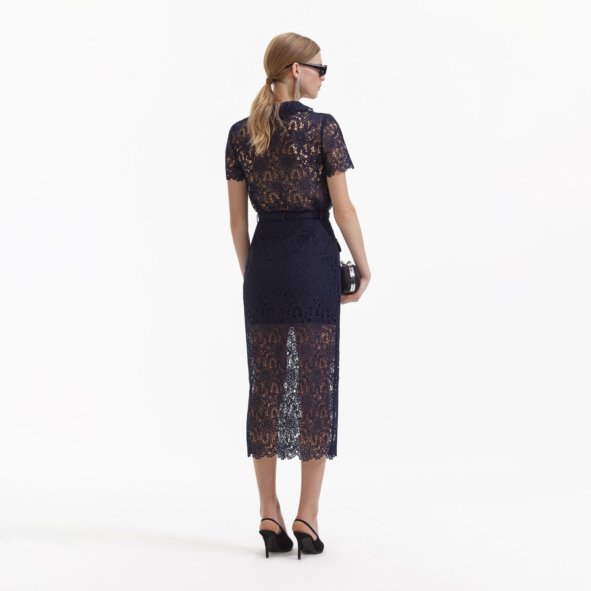 Back view of a woman wearing the Navy Guipure Lace Top