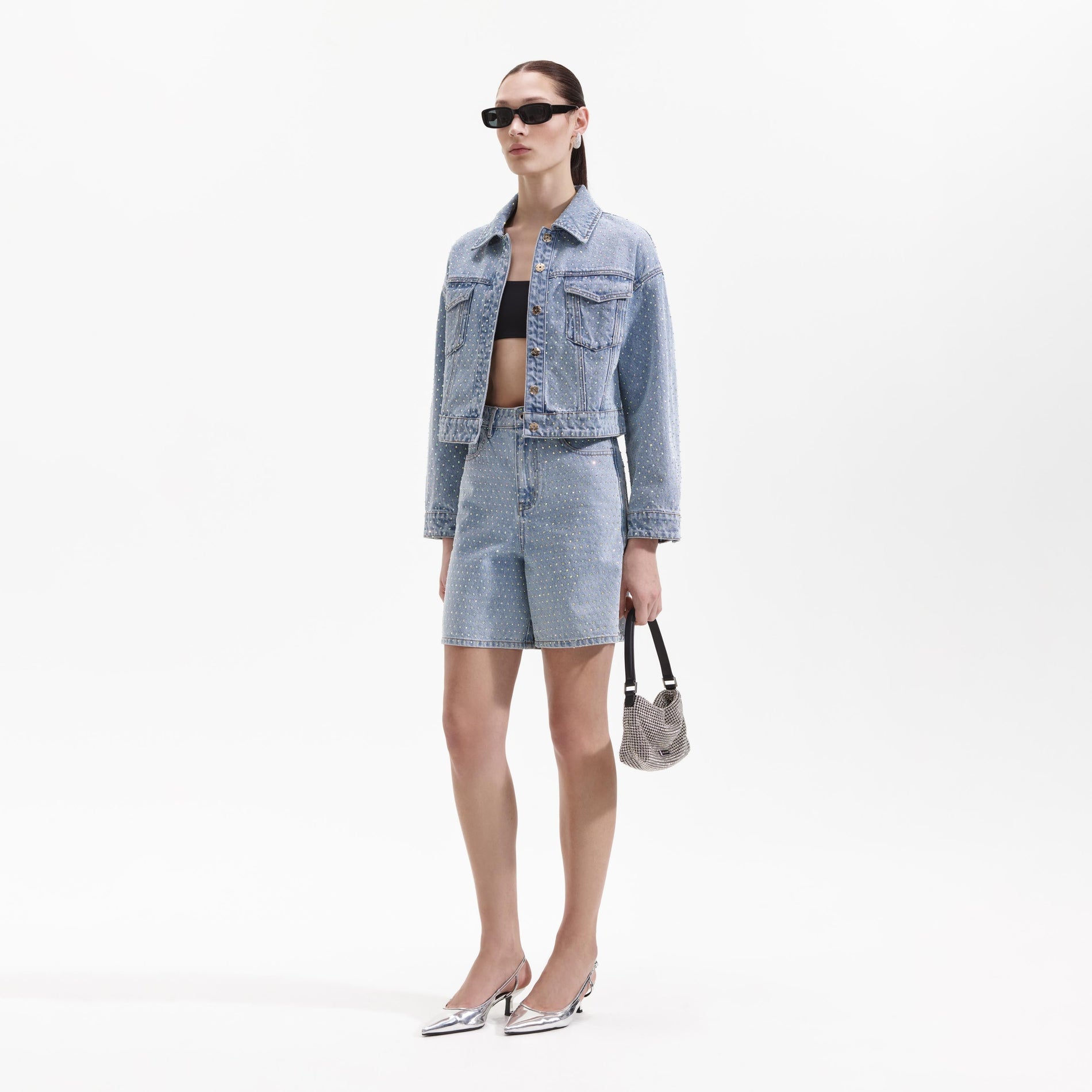 Side view of a woman wearing the Rhinestone Denim Jacket