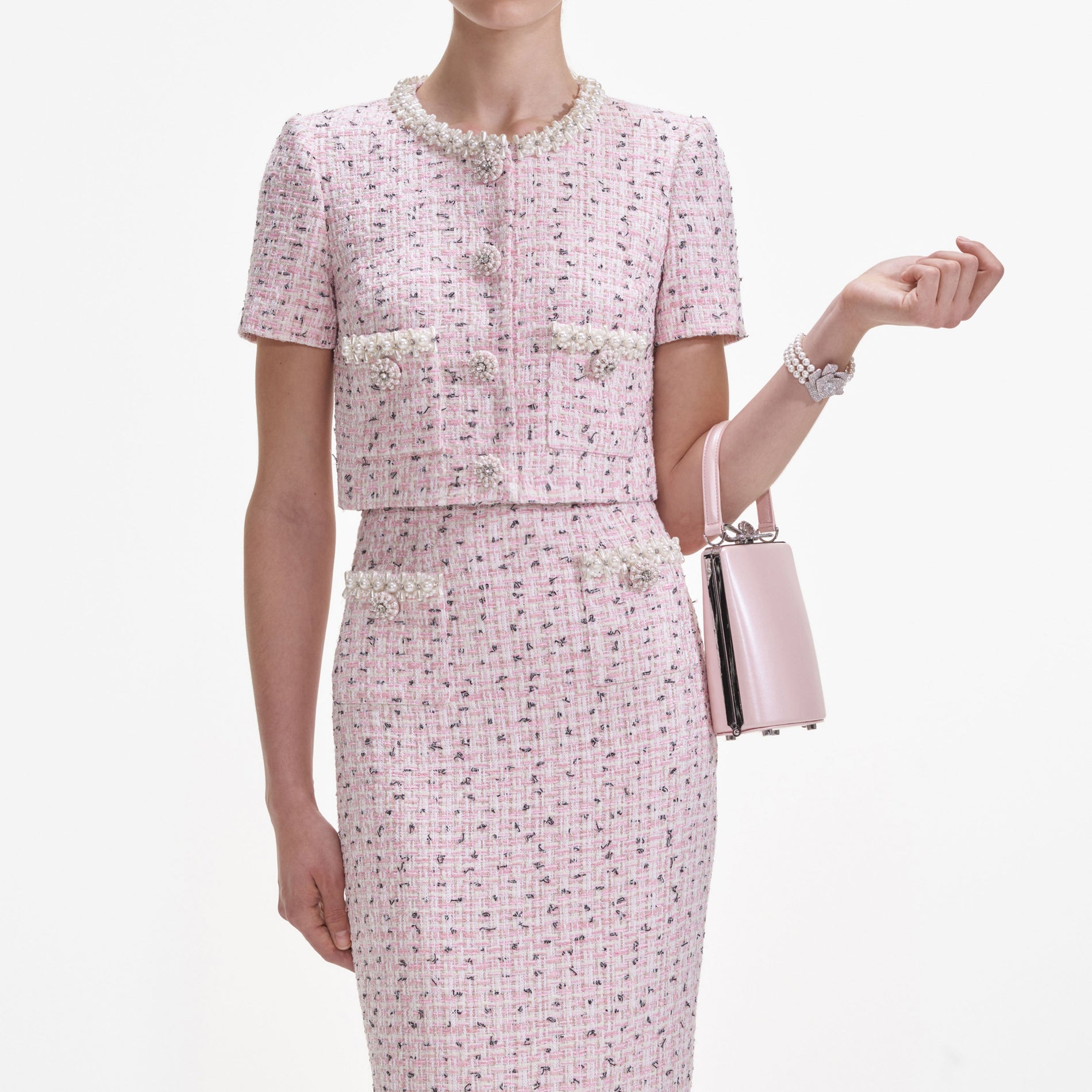 A close up of a woman wearing the Pink Boucle Pearl Top