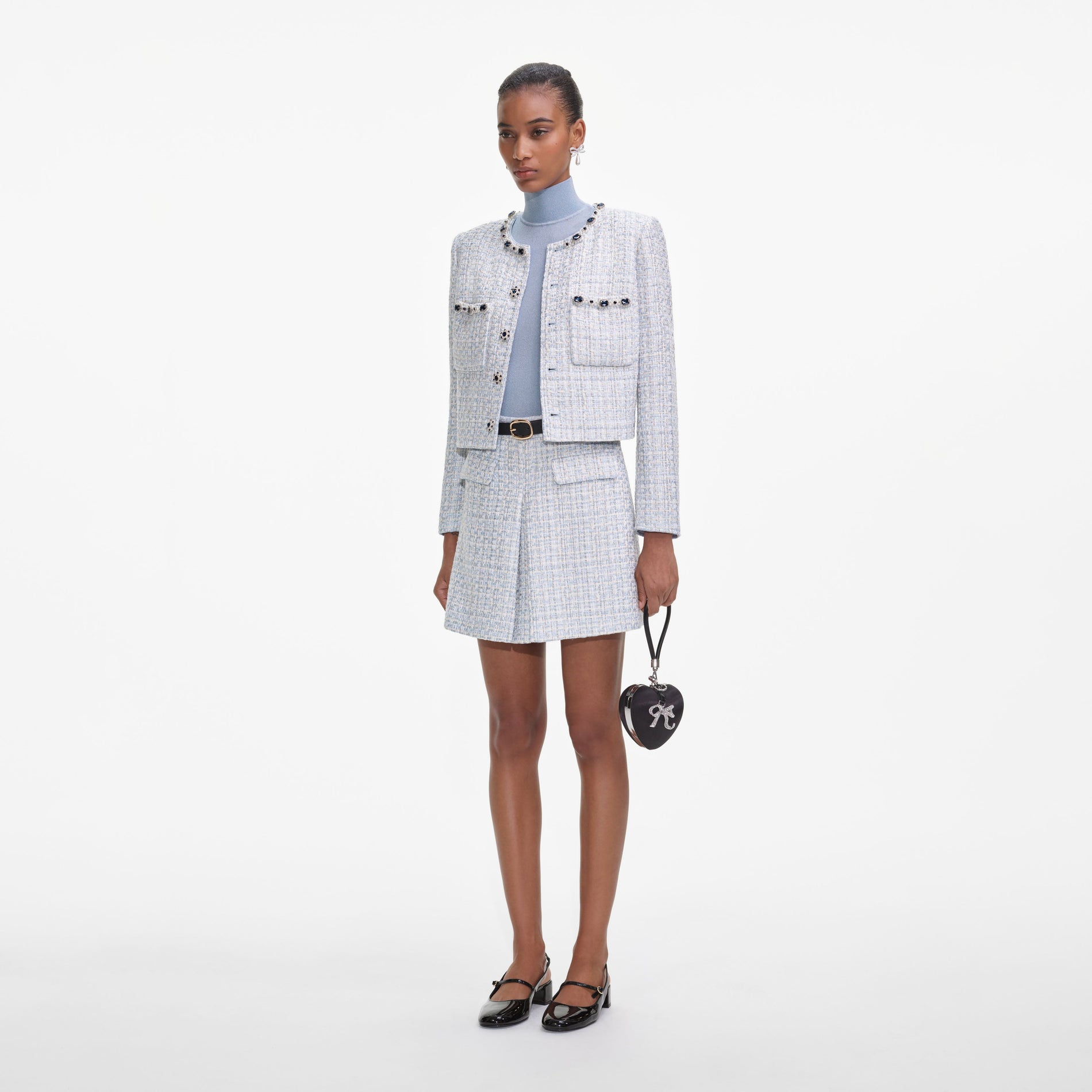 Side view of a woman wearing the Blue Boucle Mini Skirt