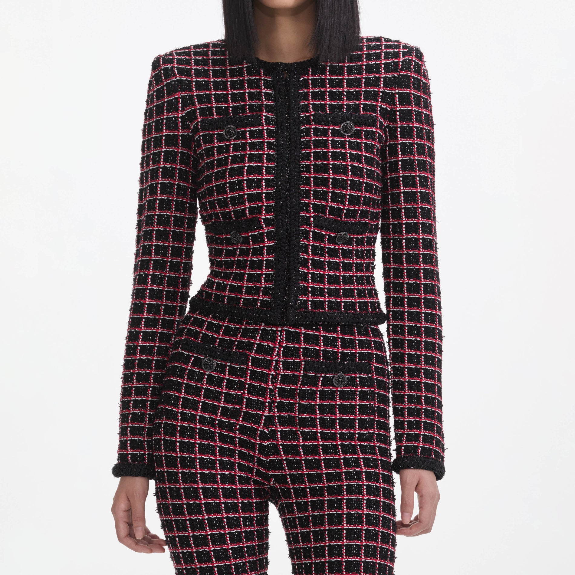 A close up of a woman wearing the Black And Red Check Cardigan