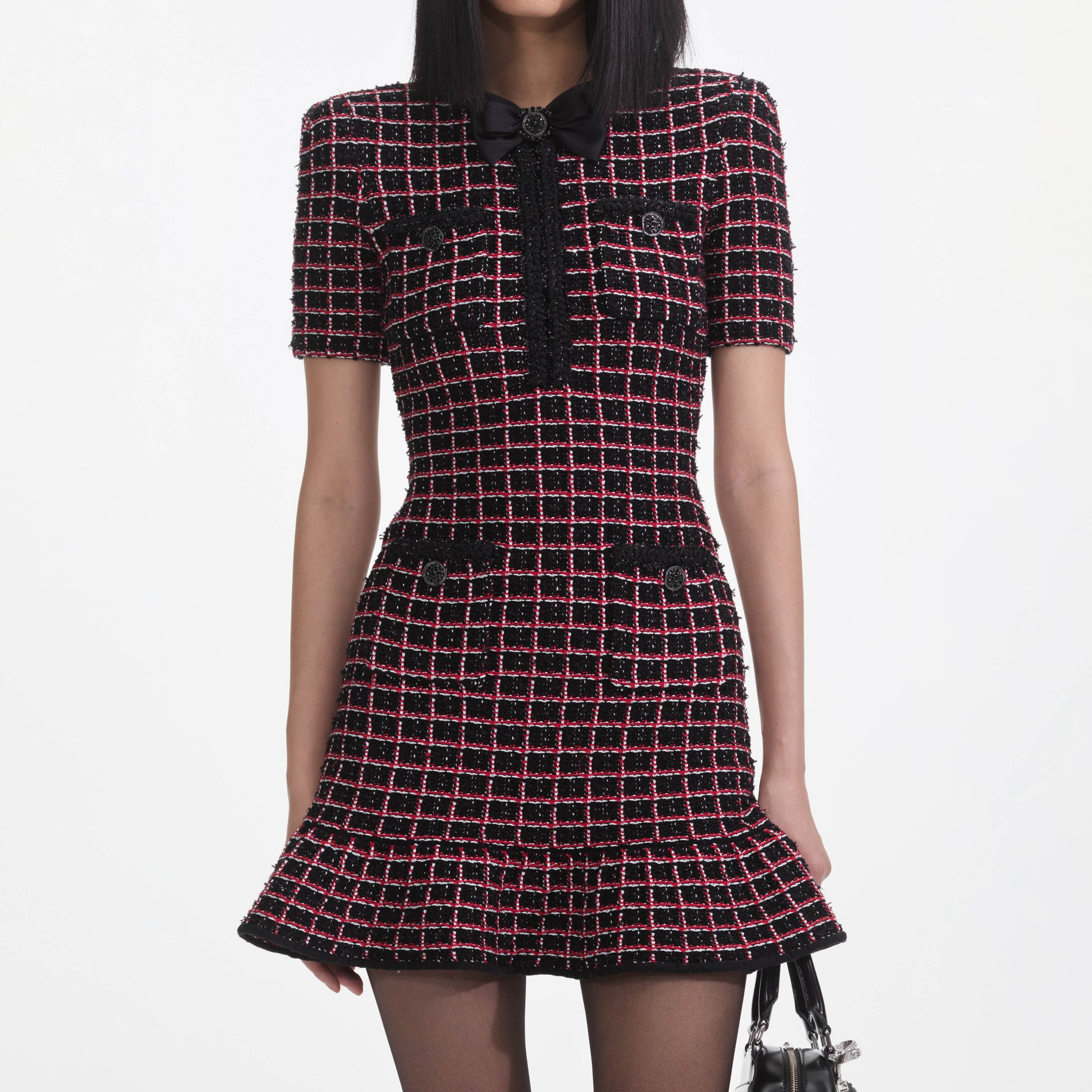 A close up of a woman wearing the Black And Red Check Knit Mini Dress