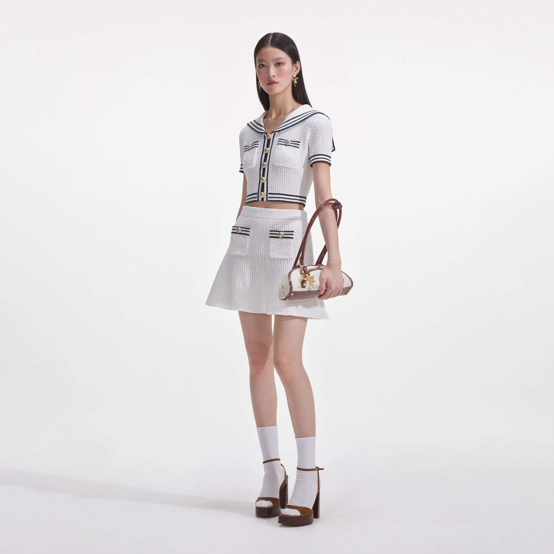 Side view of a woman wearing the White Textured Knit Top