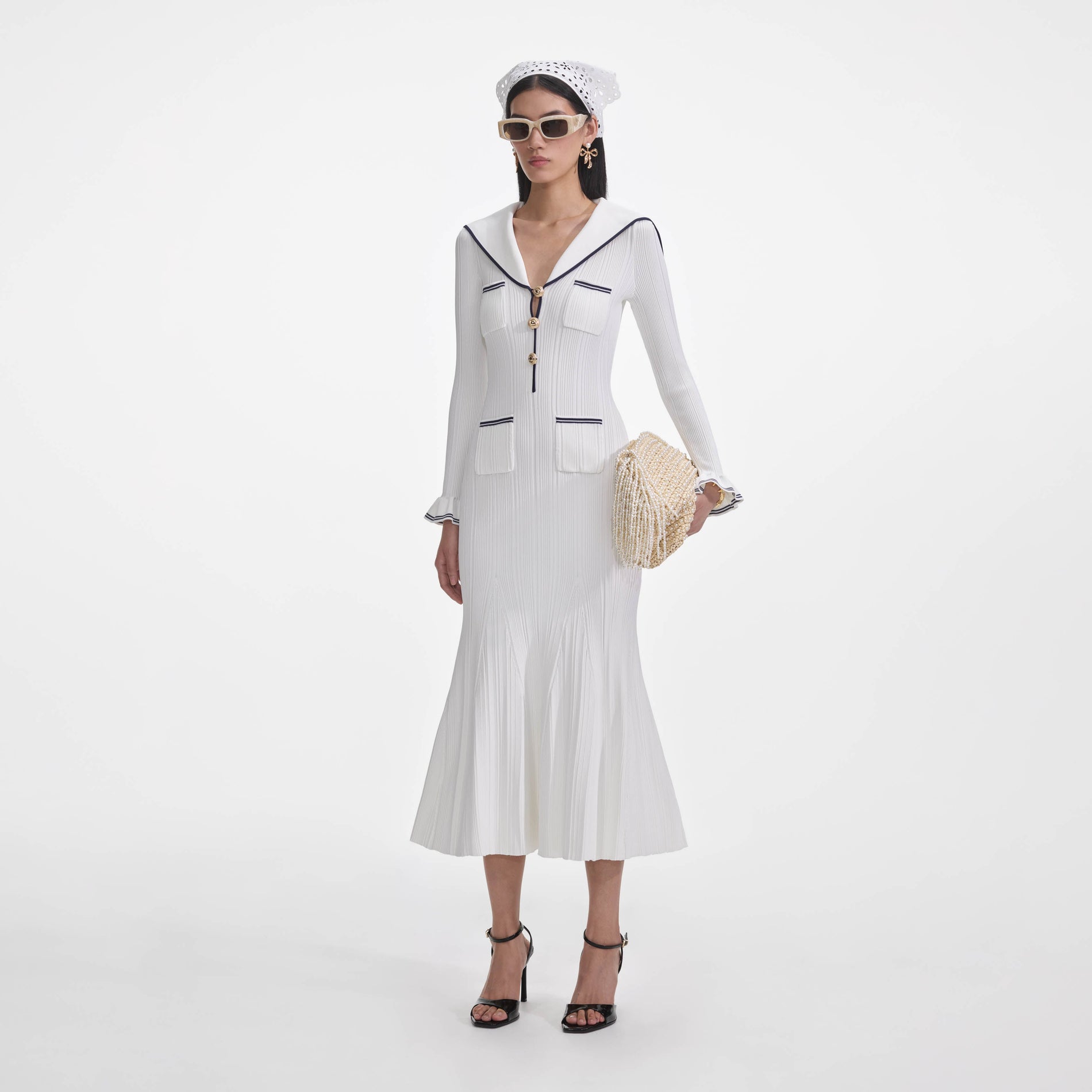 Side view of a woman wearing the White Viscose Rib Knit Midi Dress