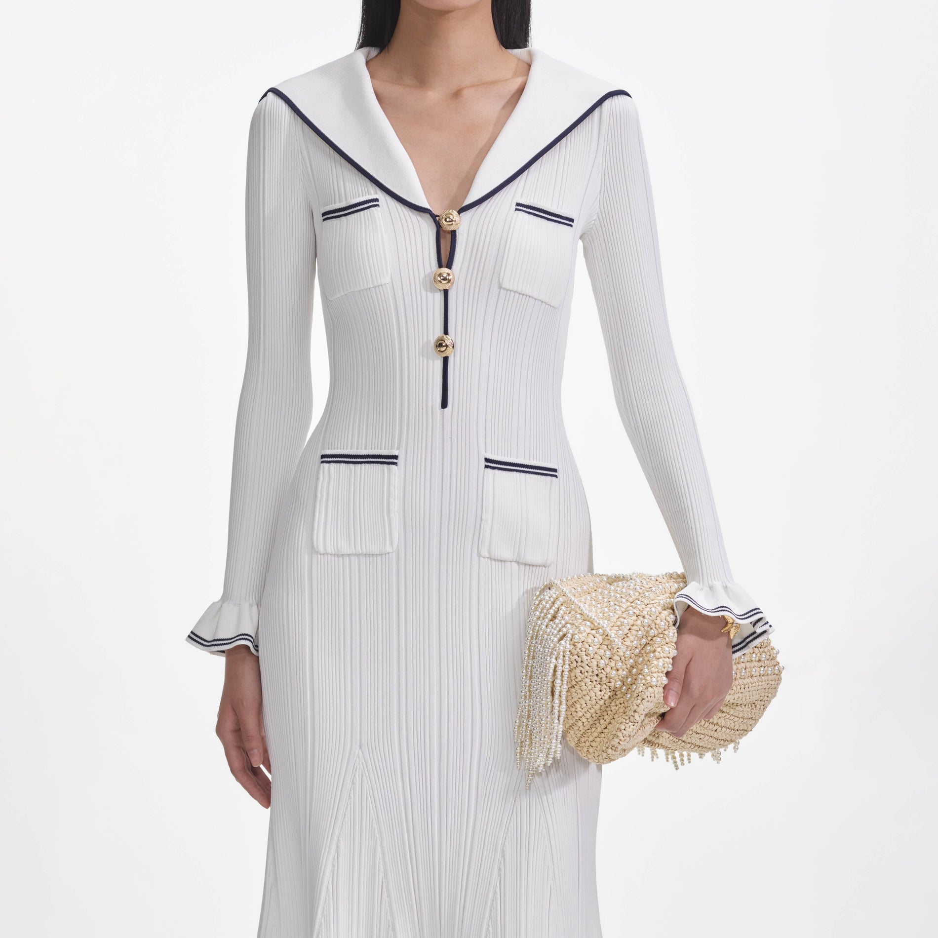 A close up of a woman wearing the White Viscose Rib Knit Midi Dress