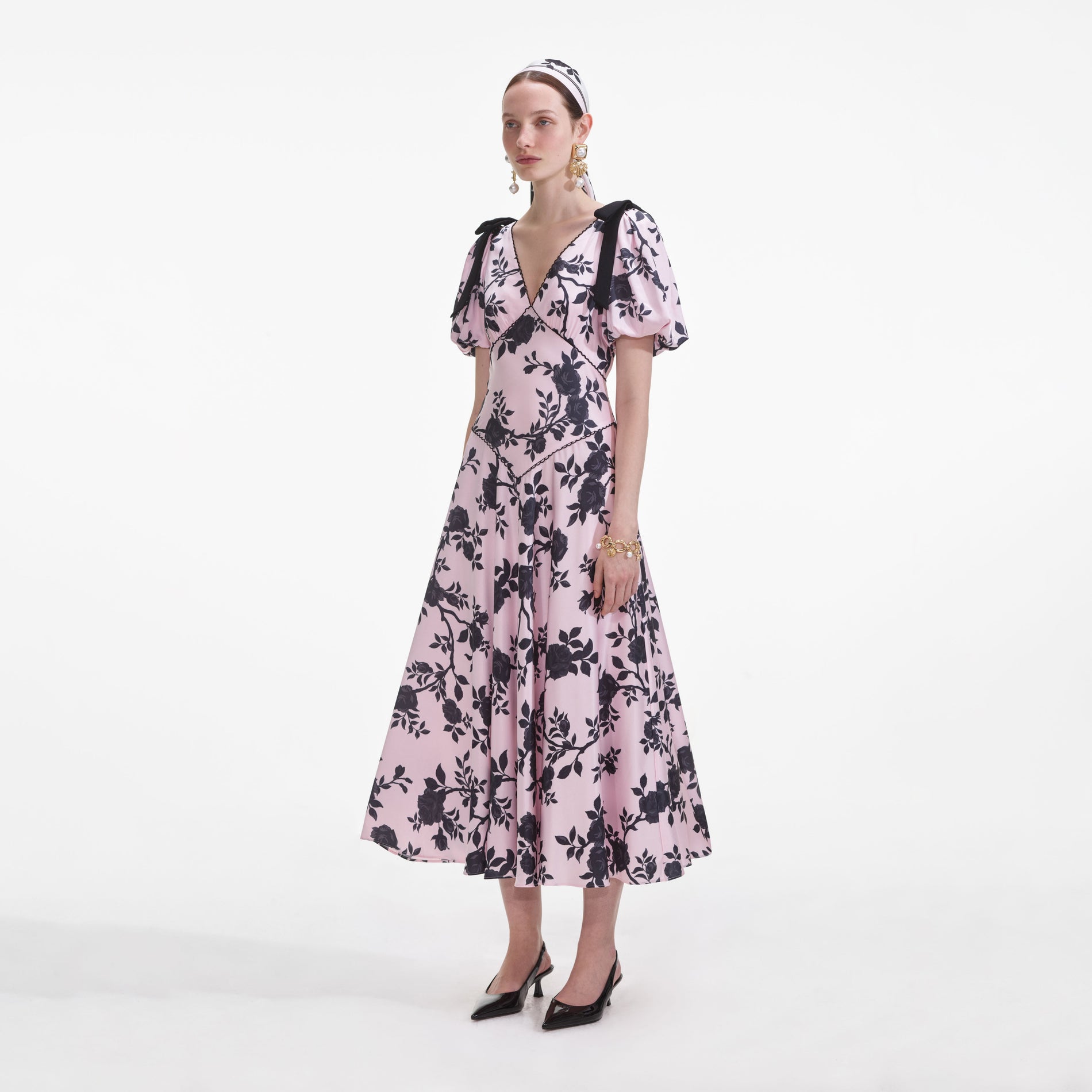 Side view of a woman wearing the Pink Satin Floral Midi Dress