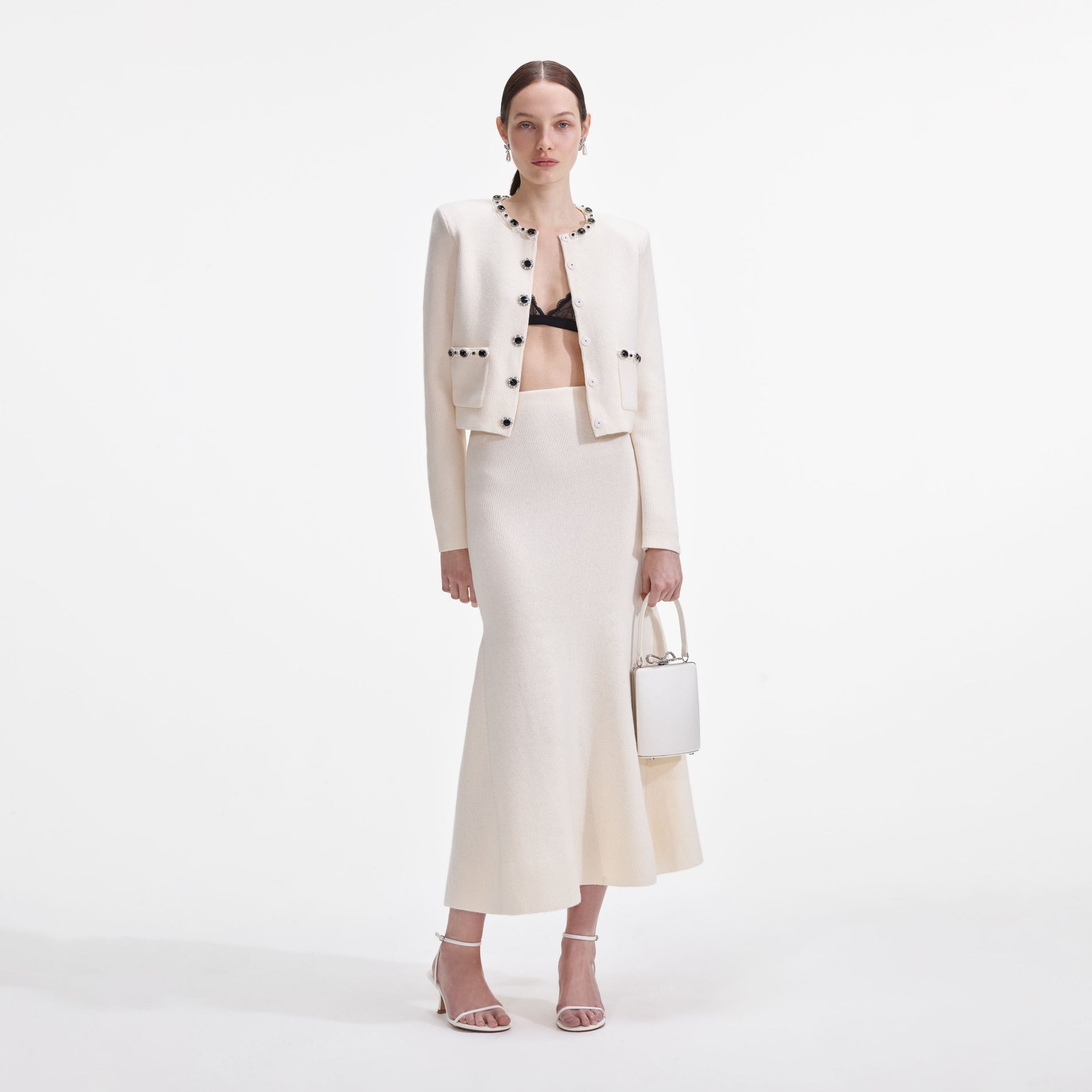 A close up of a woman wearing the Cream Embellished Cardigan