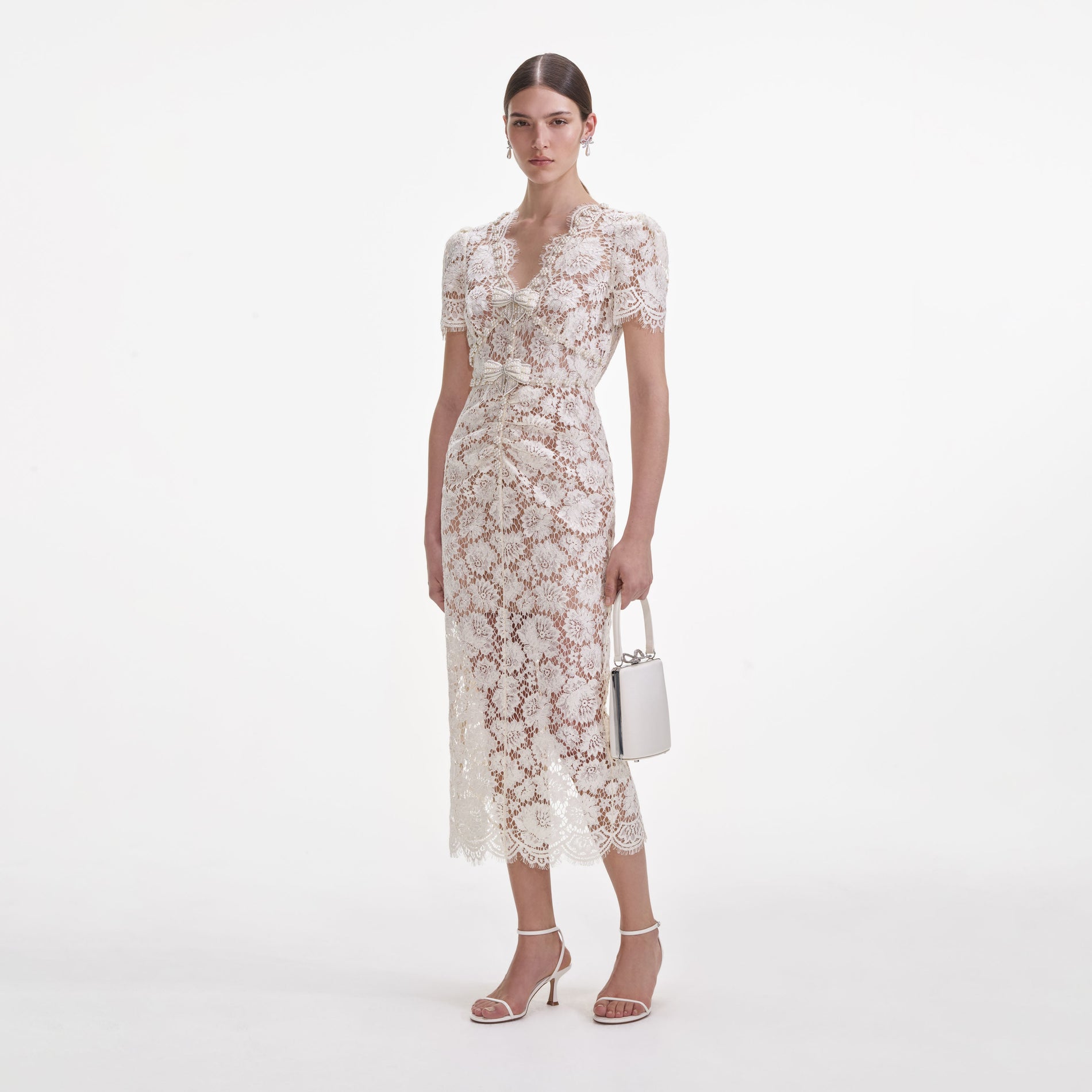 Side view of a woman wearing the Cream Fine Lace Pearl Midi Dress